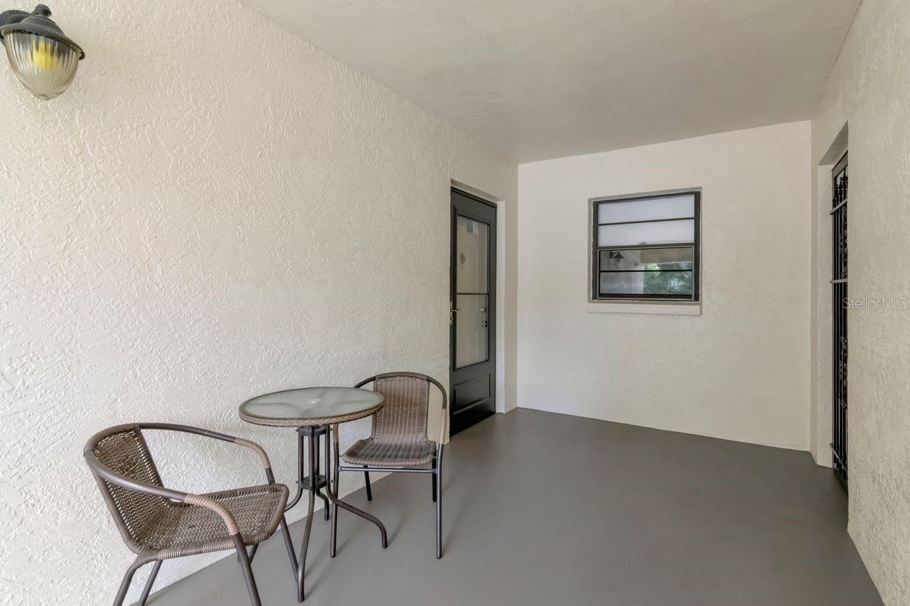 Breezeway in front of unit door on left