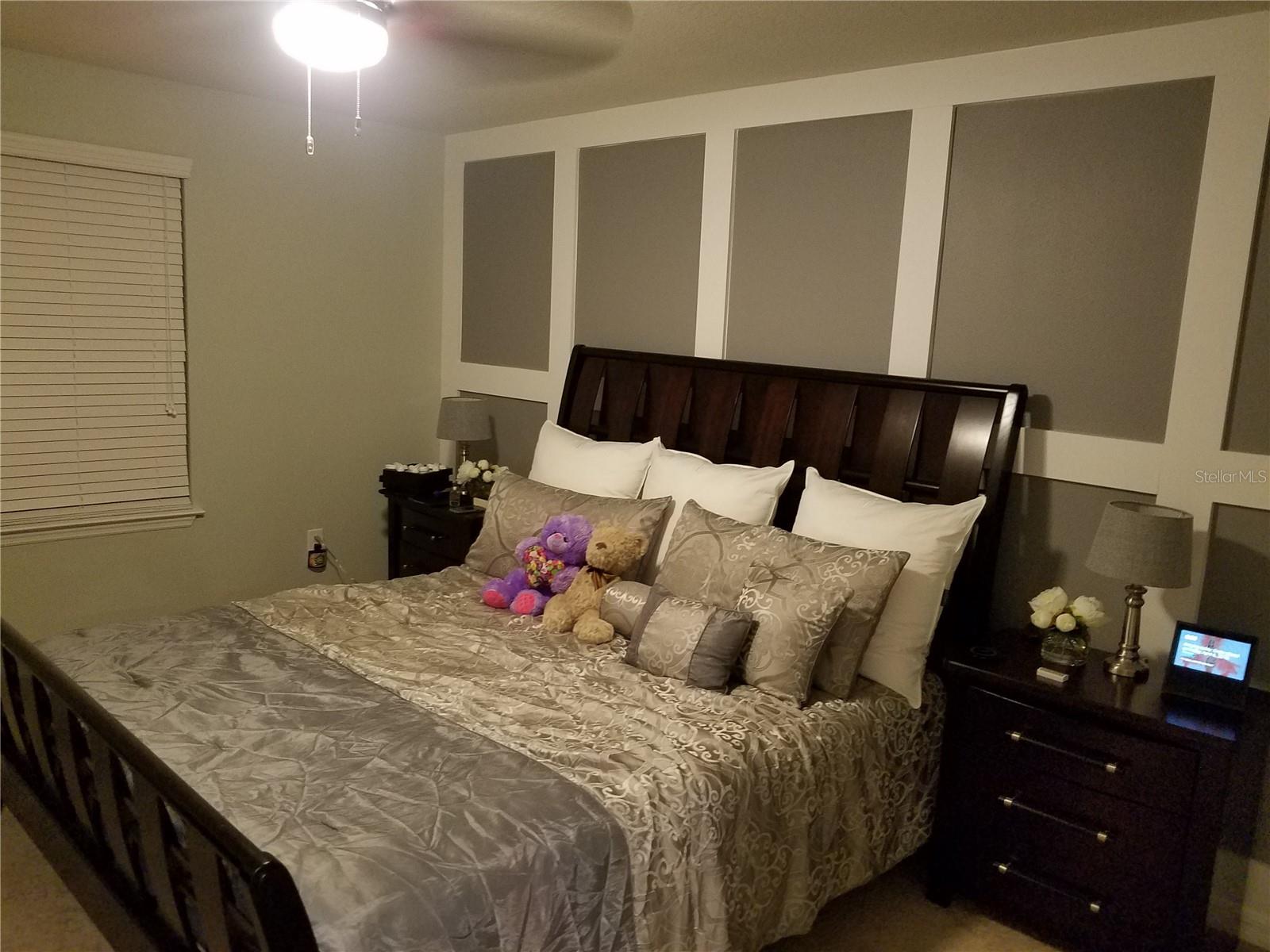 Beautifully upgraded primary suite with custom accent wall, generous space, and a calm, inviting ambiance—your private retreat at the end of the day.