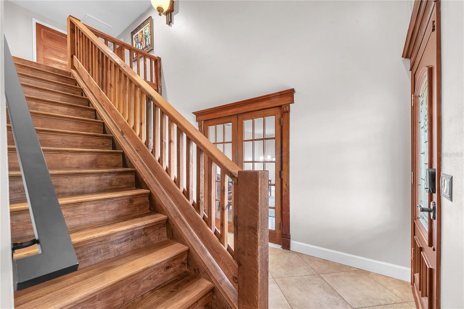 Just inside the front door there is an office or Den on your left and an additional room and bedroom suite beyond behind the french doors on the right.