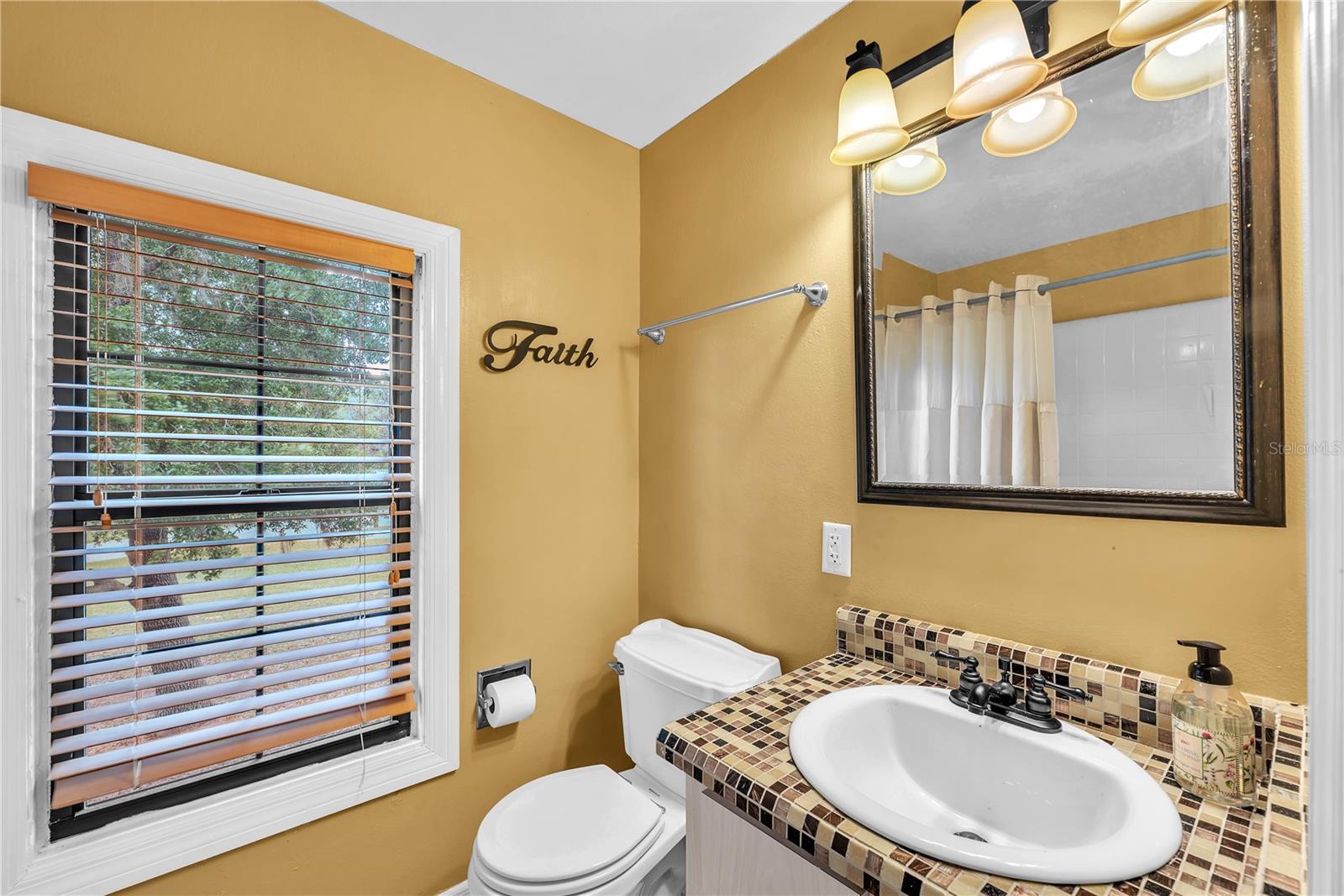 Full bathroom with tub/shower combination connected to secondary bedroom upstairs.