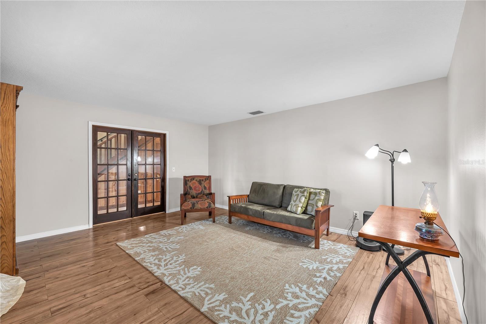 The room to the right of the foyer behind solid wood french doors is additional living space.
