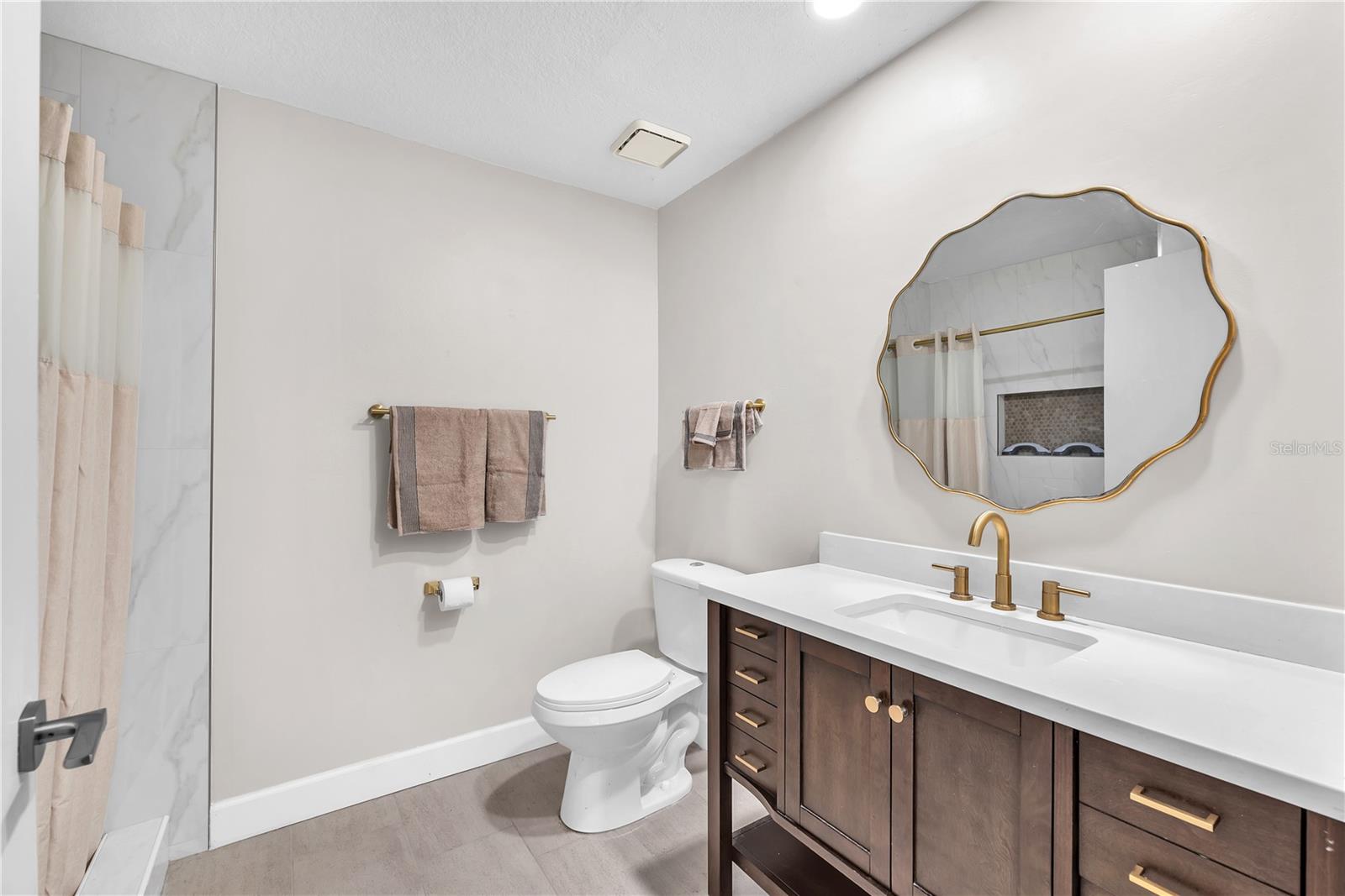 Full bathroom ensuite with step-in shower with direct access to first floor bedroom next to the flexible living space behind the rench doors.