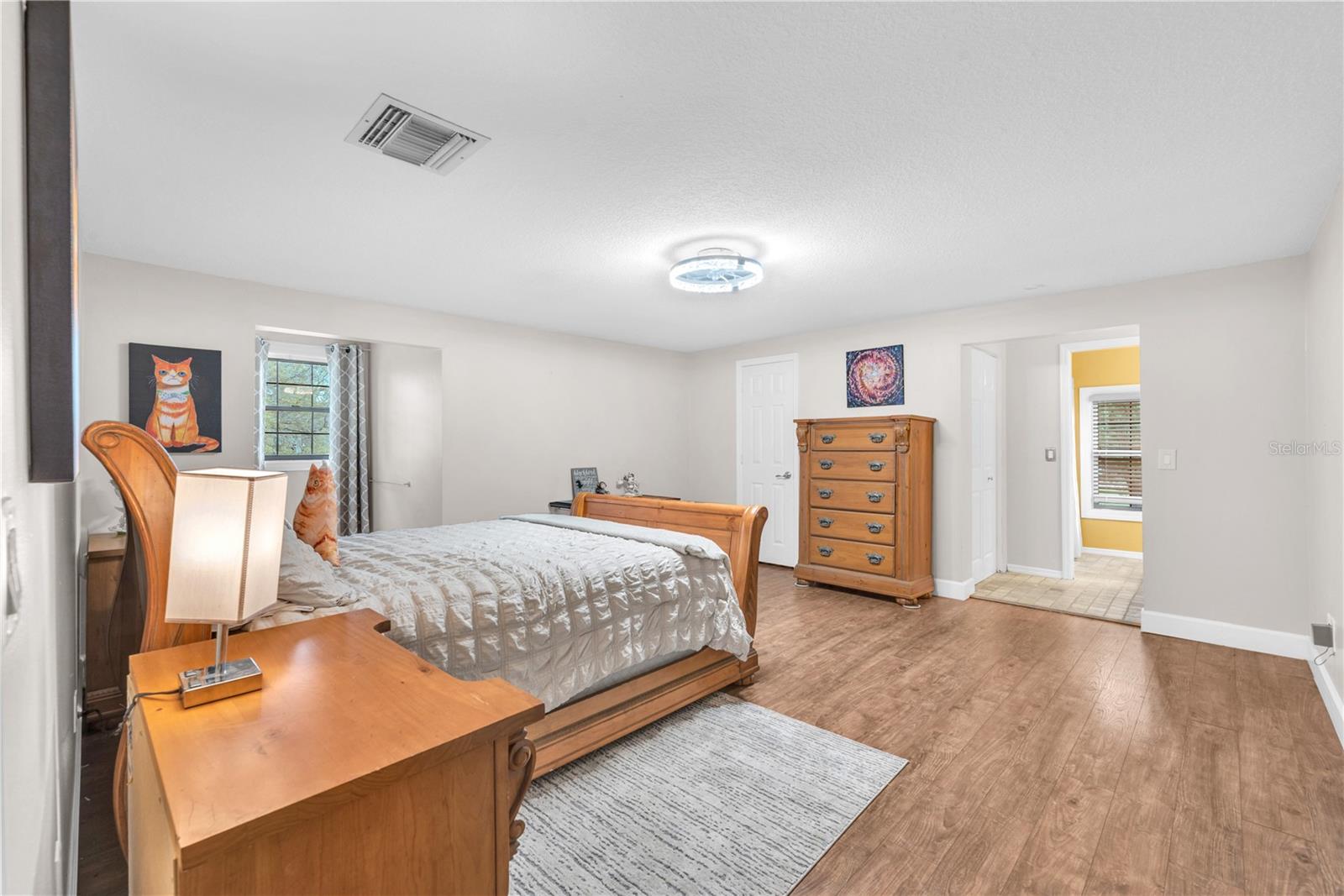 Secondary bedroom upstairs with large walk-in closet and ensuite bathroom.