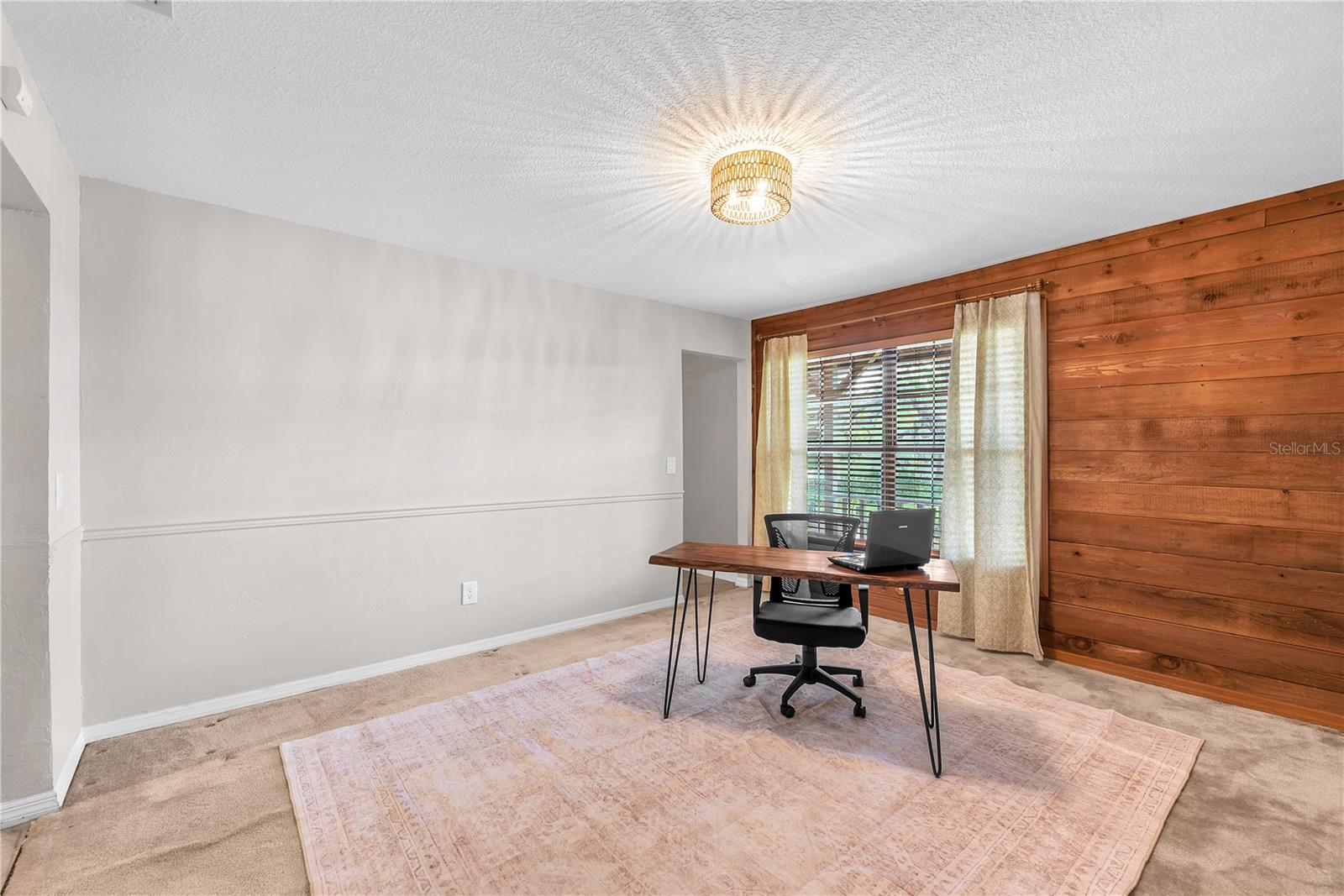 The room to the left of the foyer has exposed cedar accents adding warmth and timeless character.  This room would make a great office space or formal dining area.