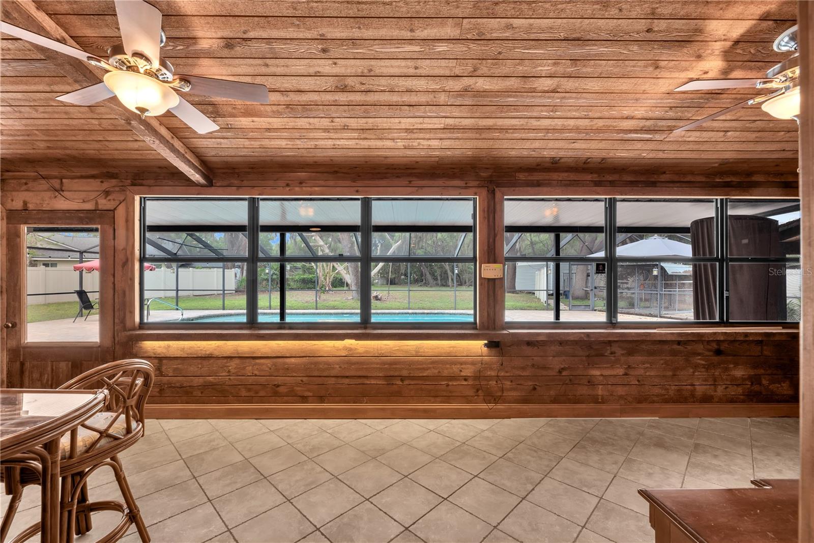 Florida Room off the living room and kitchen is under air and fully clad in cedar wood.