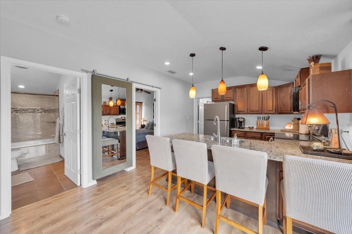 Guest house alternate kitchen view with seamless flow to bedroom and bathroom