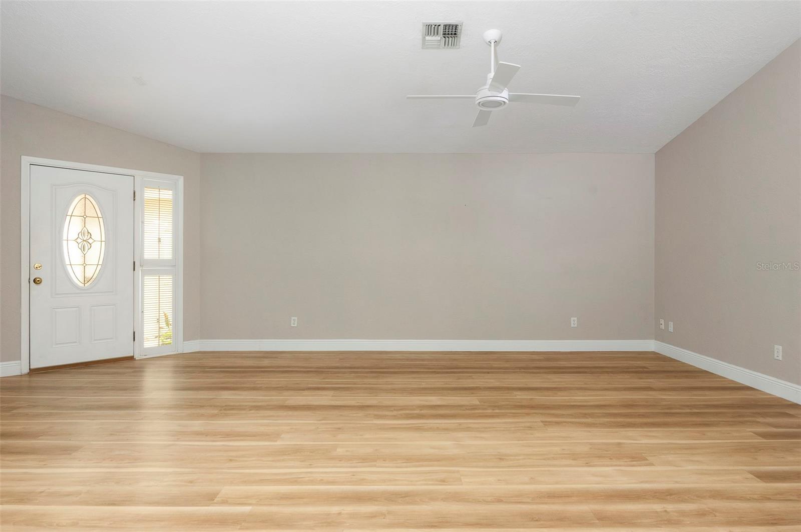 Living room with front door entrance