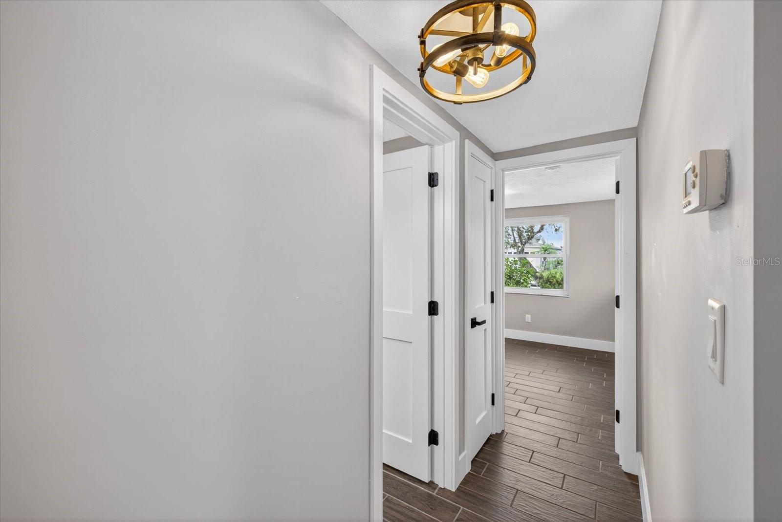 Hallway leading to second bathroom and bedroom