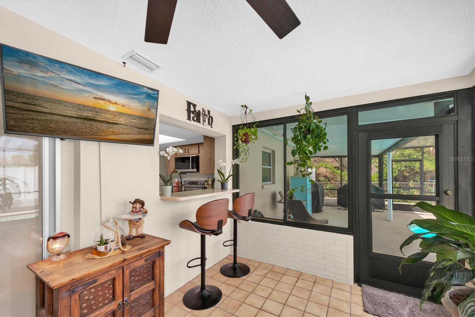 Pass thru window from kitchen to Florida room with solid counter that overhangs to allow additional stool seating!