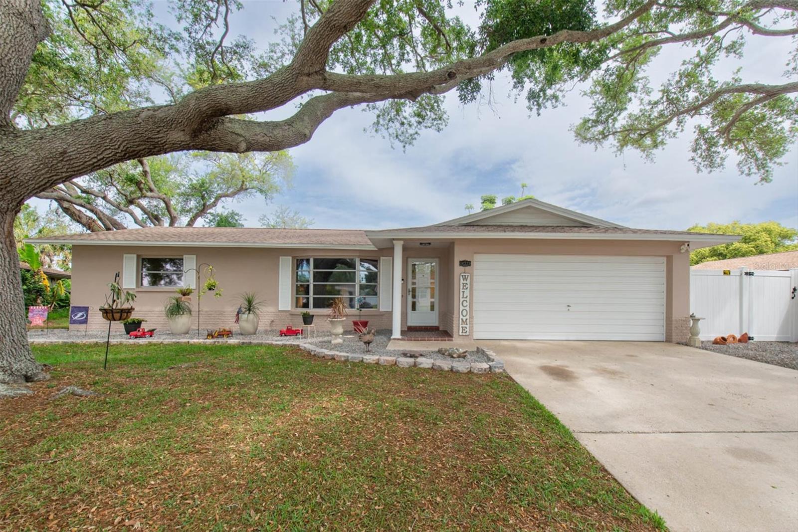 Beautiful curb appeal!  Tree all trimmed off the home but still allows shade!