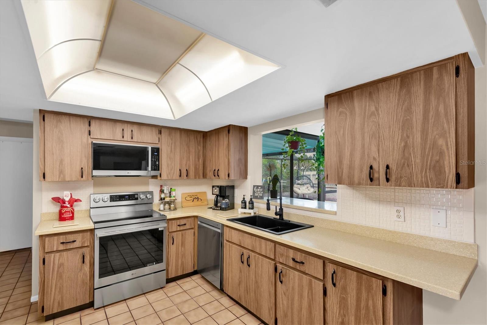 Kitchen with newly installed solid surface countertops and updated hardware.