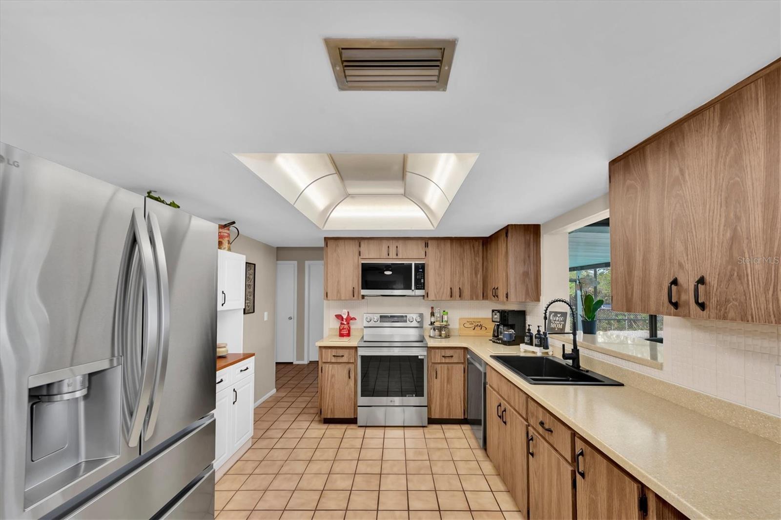 Spacious kitchen with tile flooring.