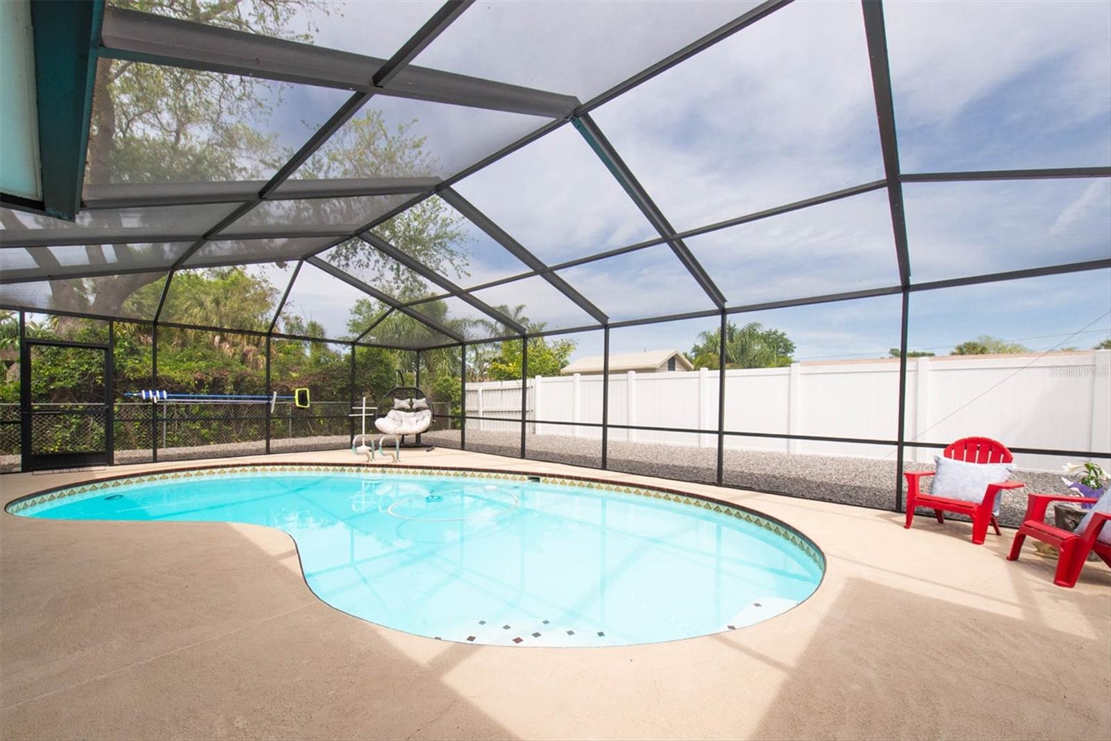 Vinyl fencing and shrubbery gives privacy.