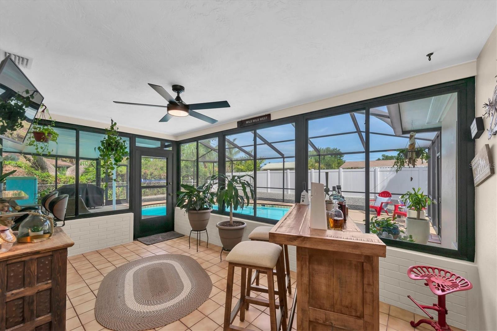 Florida room overlooking the screened in pool area great for entertaining!