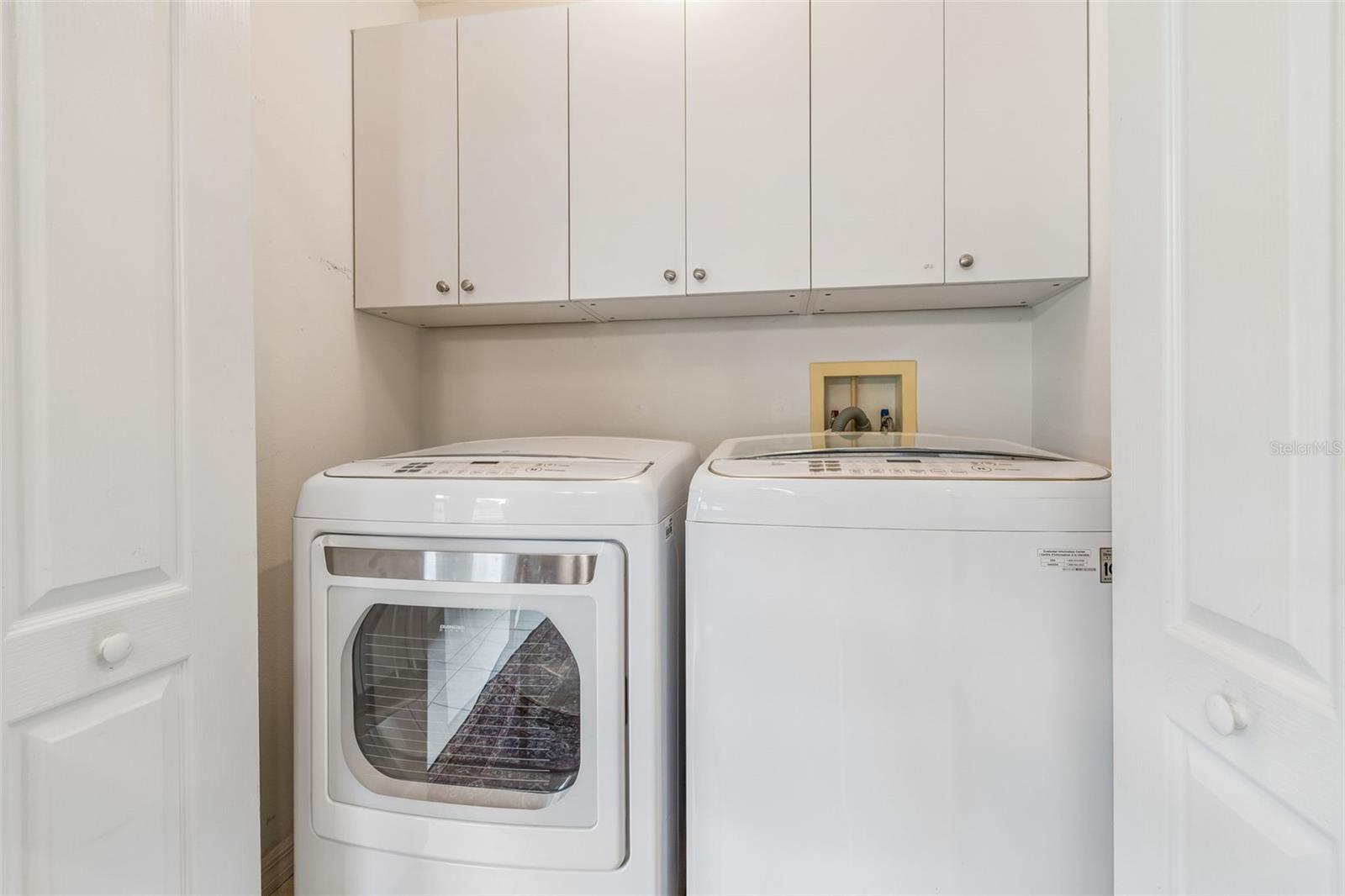 Washer and Dryer Inside with cabinetry