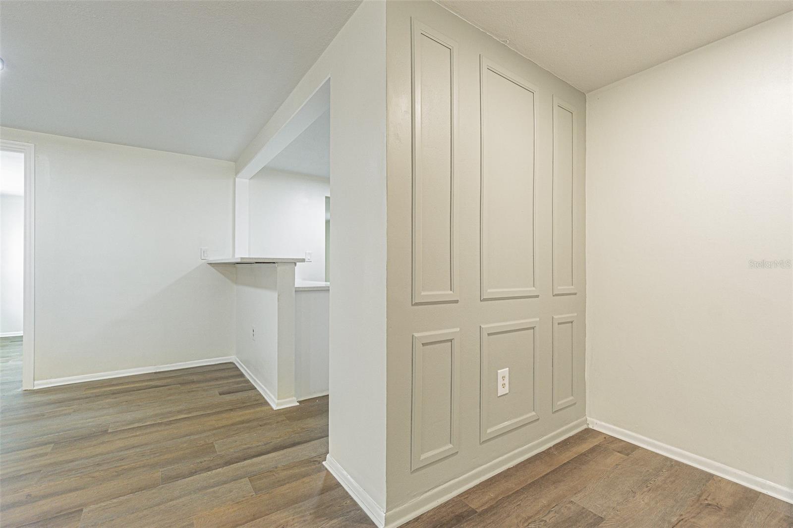 Sage, accent wall leading to kitchen