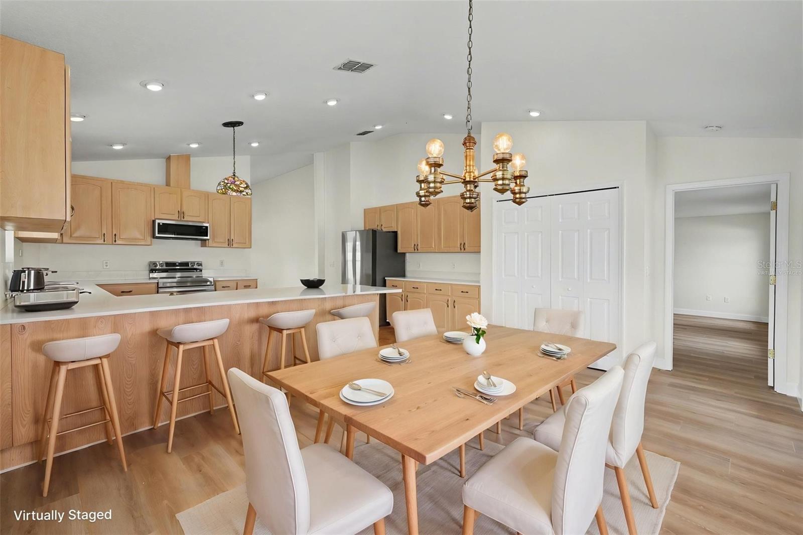 Virtually staged to show the potential to have a dining rom table in the kitchen space