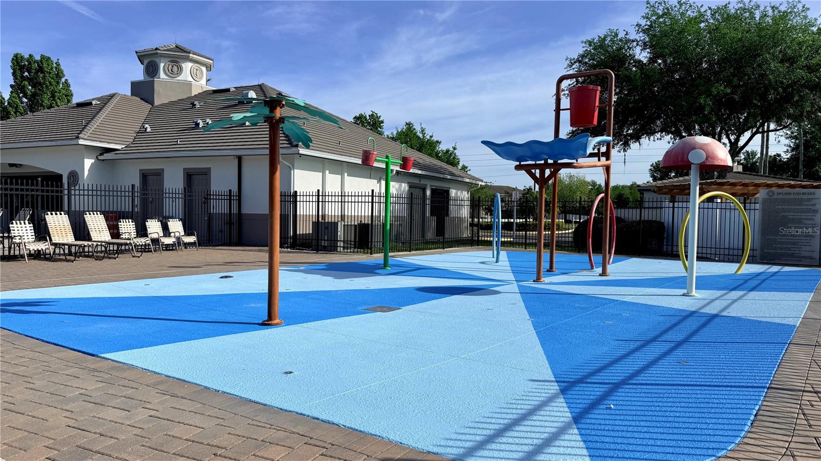 Community Splash PadA fun-filled community splash pad features multiple interactive water play elements, rubber safety surfacing, poolside lounge chairs, and a clubhouse with restroom facilities — ideal for warm Florida days.