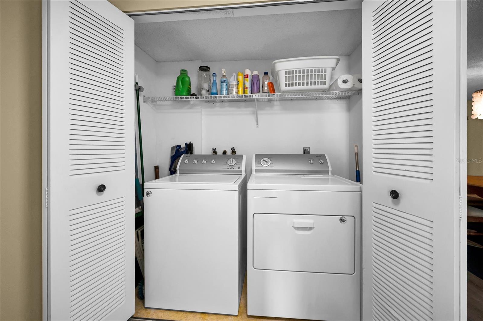 Inside Utility closet with full sized Washer & Dryer