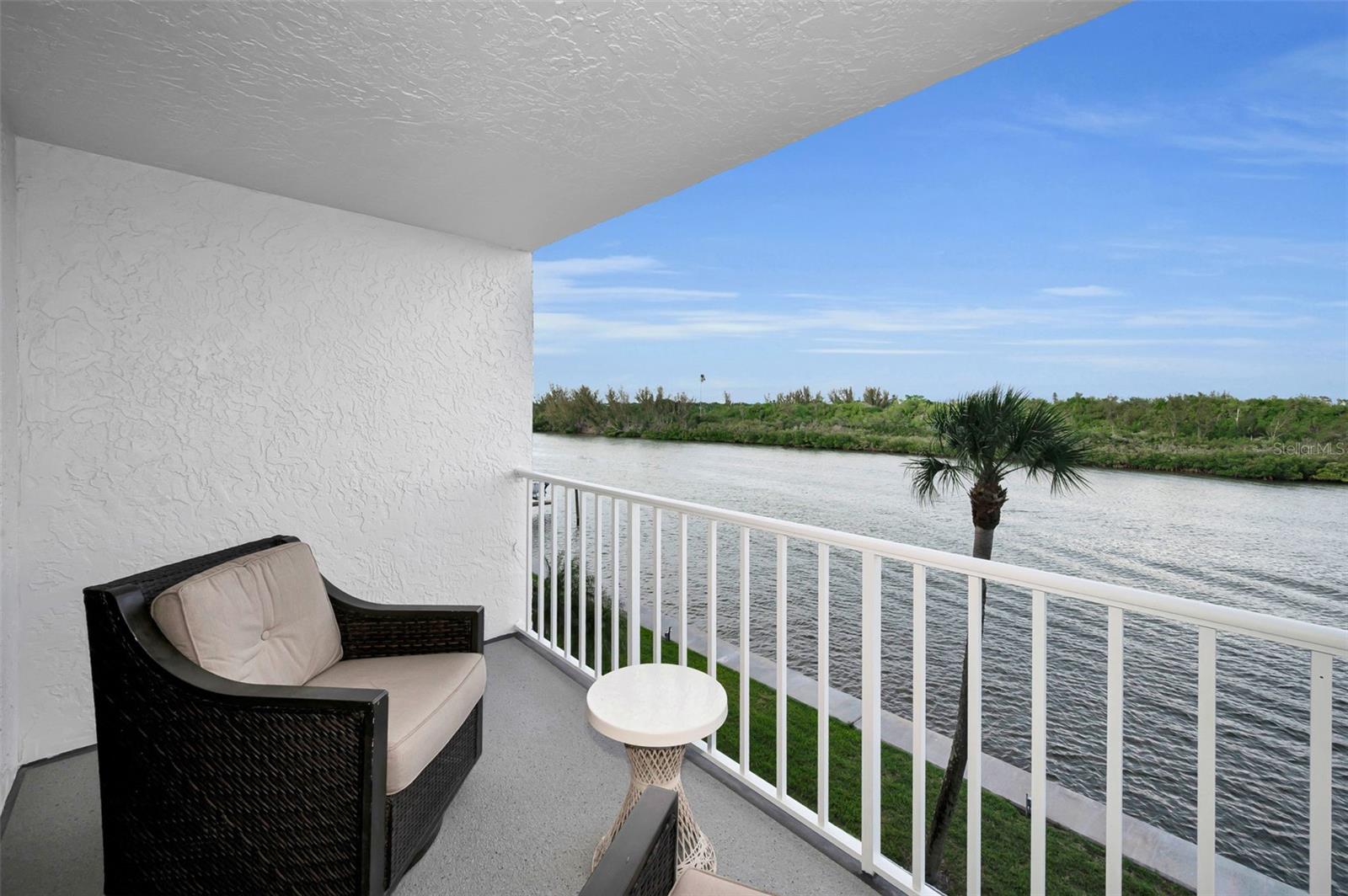 Unwind on your private balcony while taking in the tranquil waterfront views