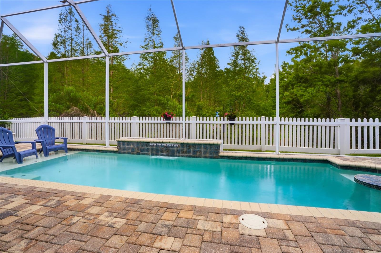 beautiful pool surrounded by pavers