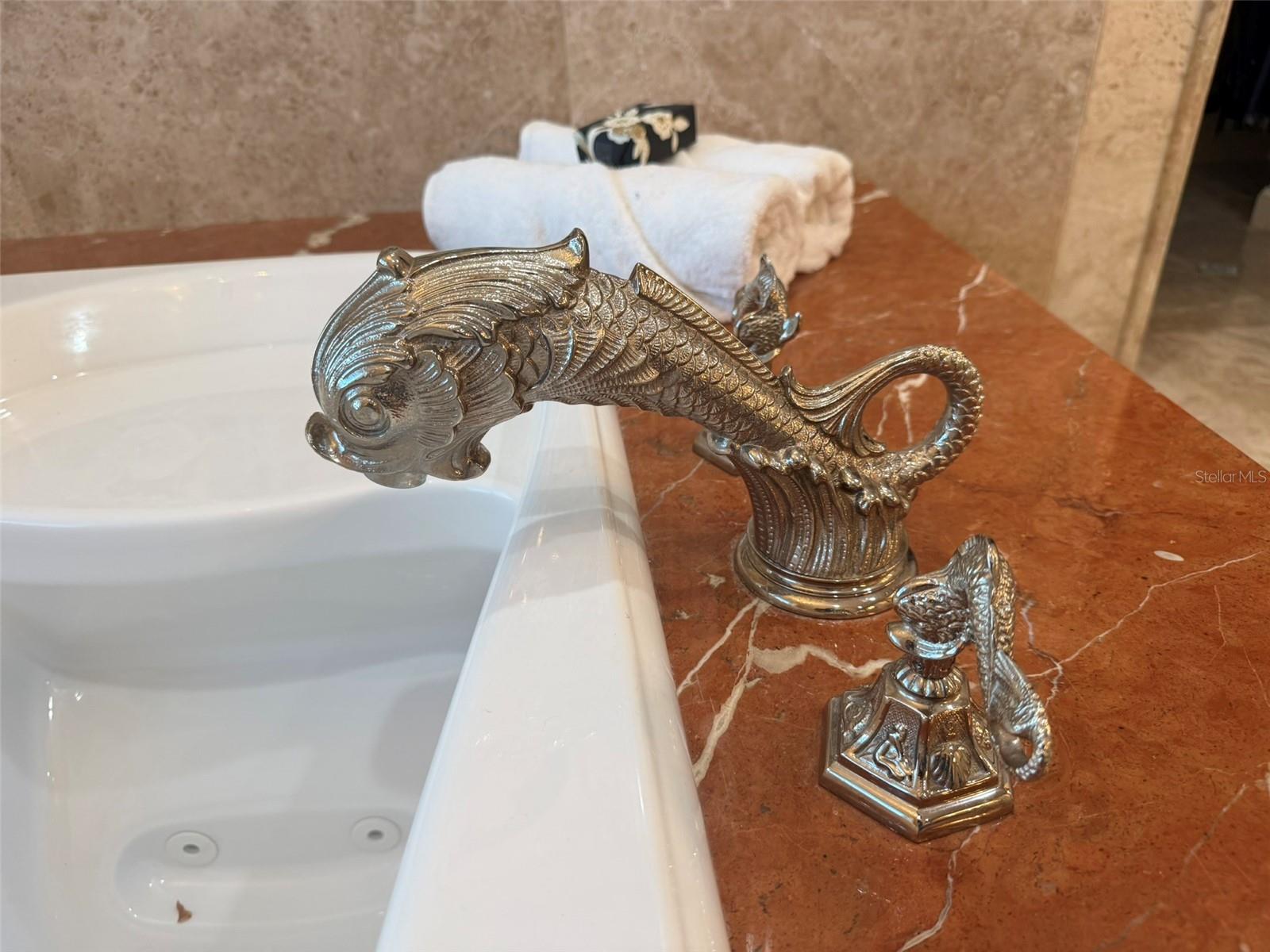 Phylrich Dolphin fixtures, a large sauna, soaking tub, multi-jet full-body rain shower, multiple vanities, and expansive custom closets