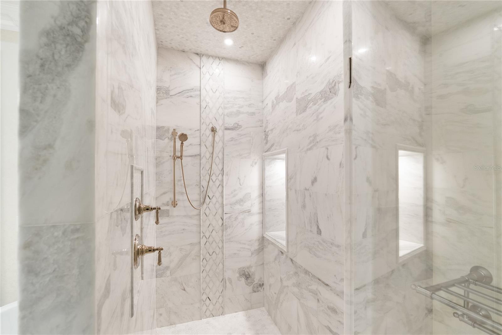 Expansive walk-in shower with modern design and a luxurious, spa-level feel.