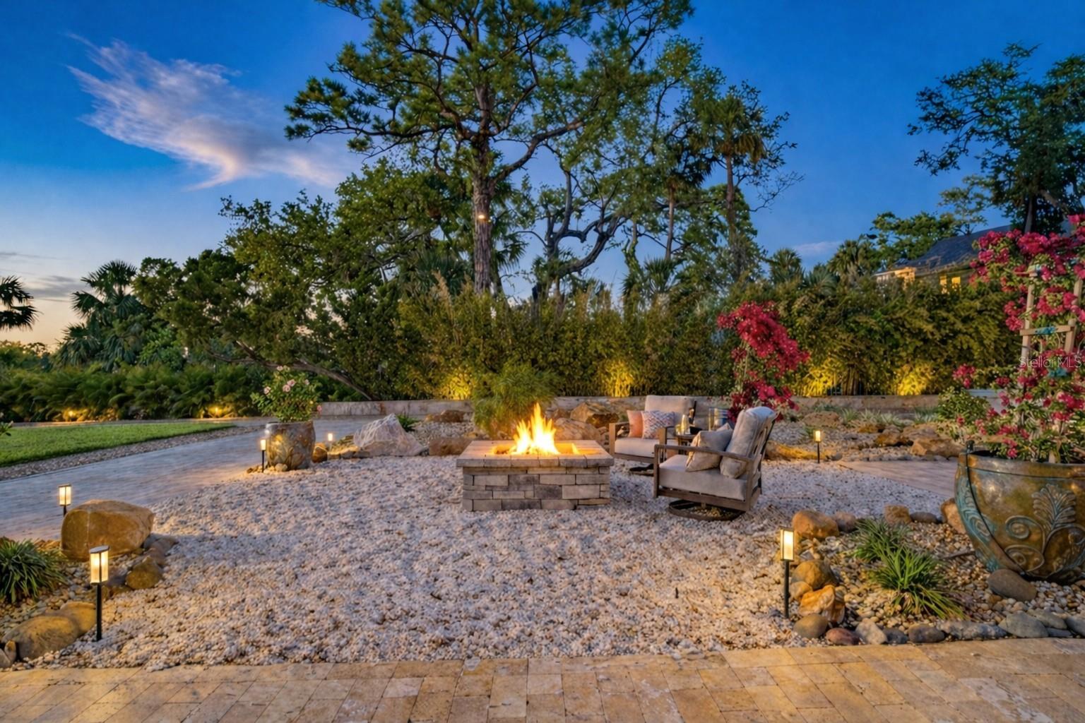 A glowing firepit sets the stage for unforgettable evenings by the water.