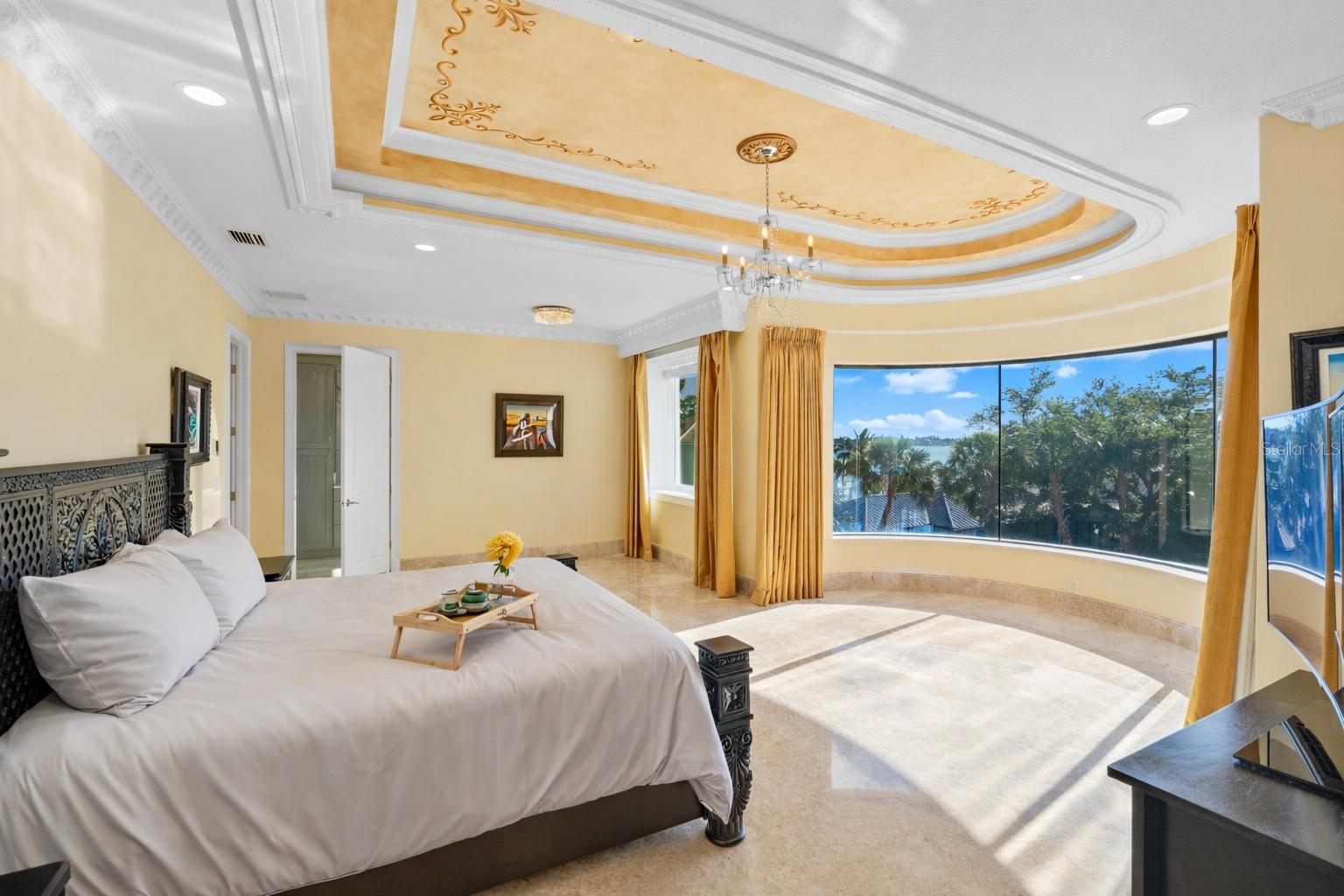 Bedroom 2 on the third level has a curved glass floor to ceiling glass window for endless views of the grounds and water.