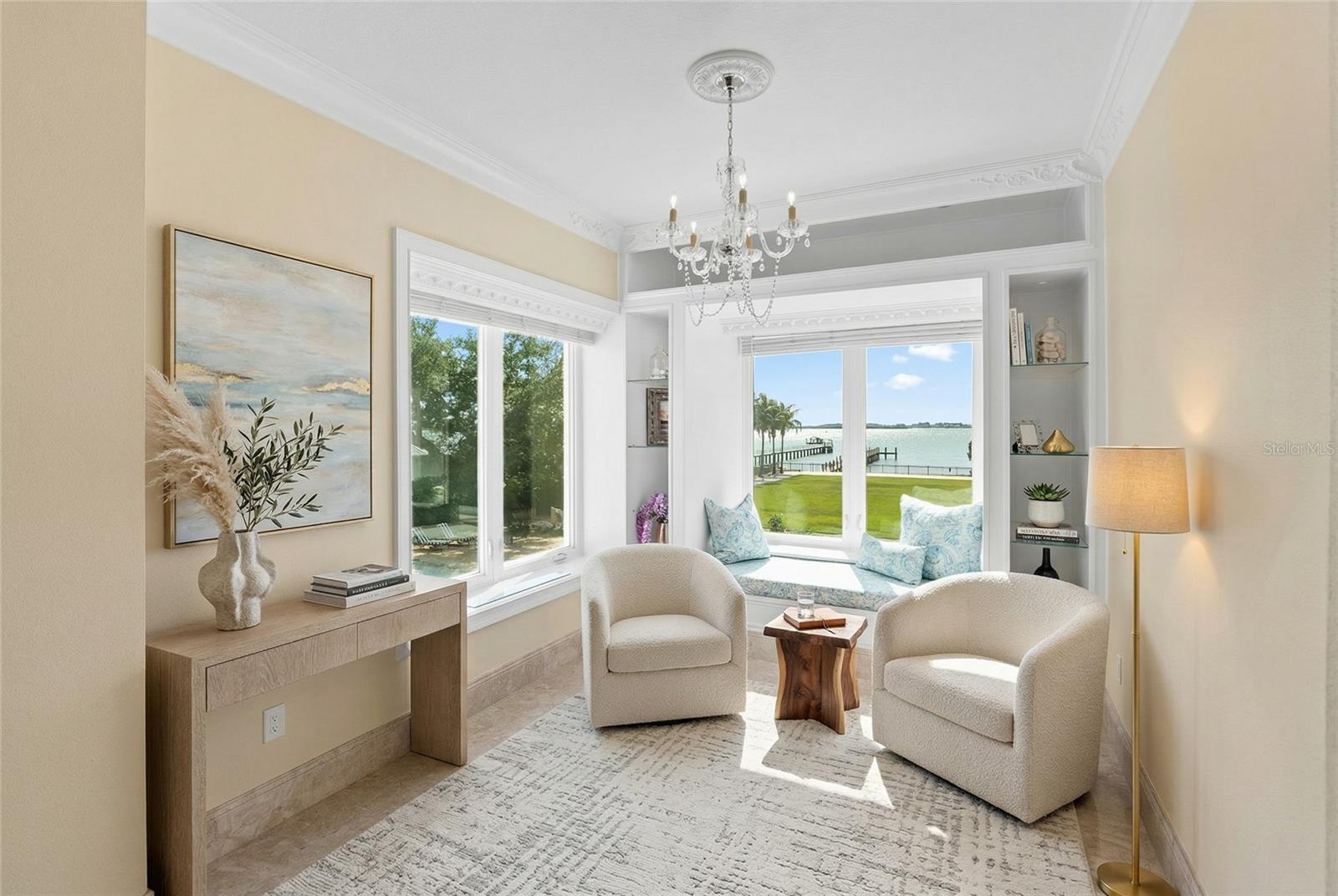 Elegant sitting area with a window seat to curl up to a good book and relax in the Primary suite with water views.