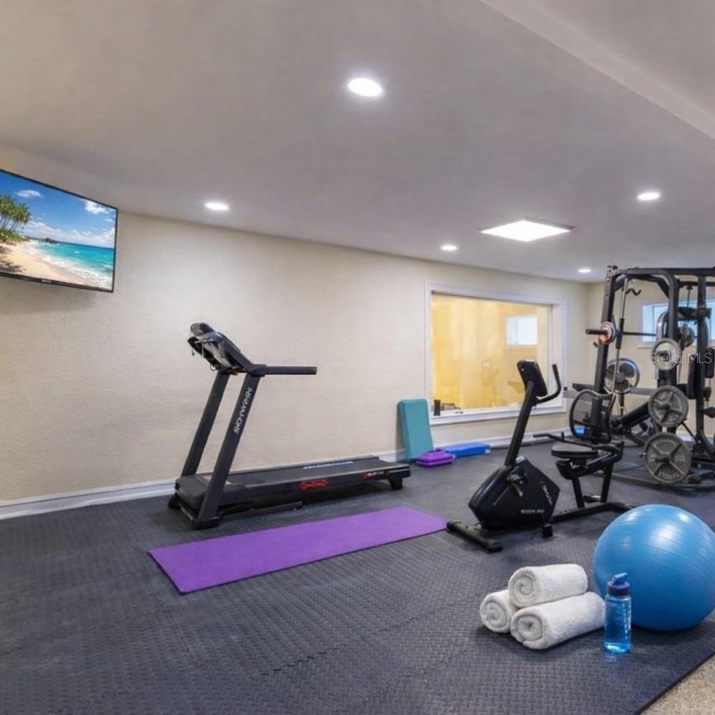 Multiple garage bays and flexible space for gym, workshop, or additional lounge.