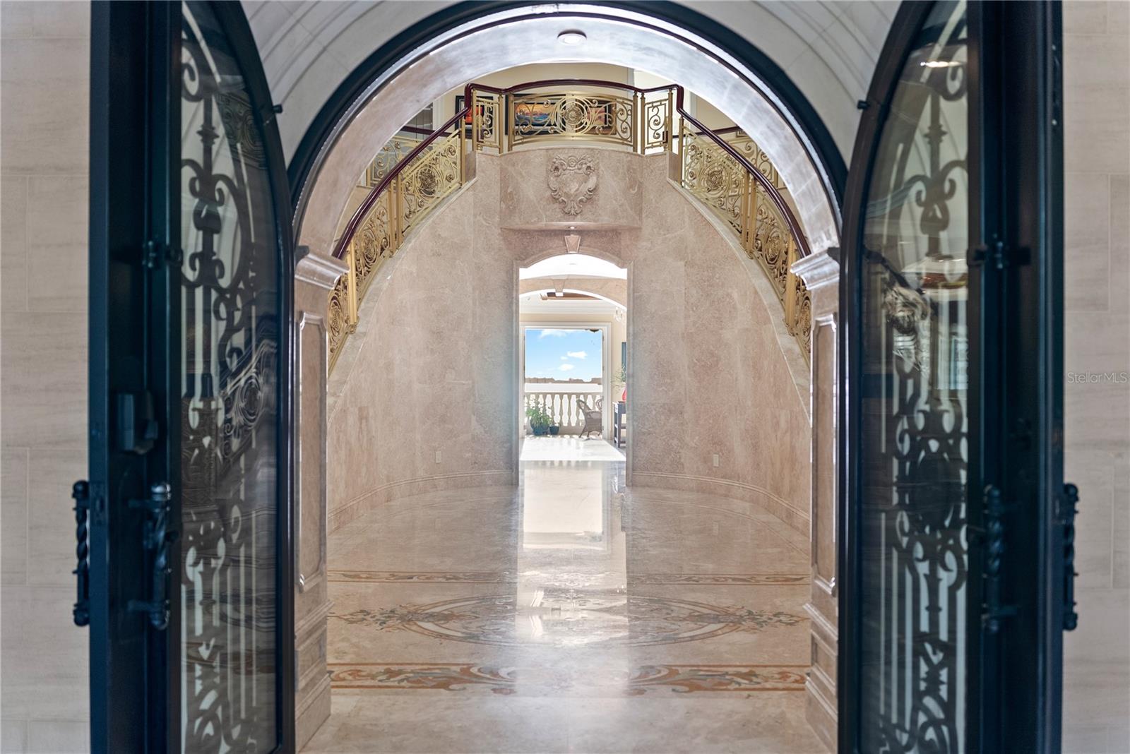 Arched Iron doors welcome you to Palazzo Sul Mare!   Opens to water views and a gallery corridor designed for art display and dramatic transitions between spaces.