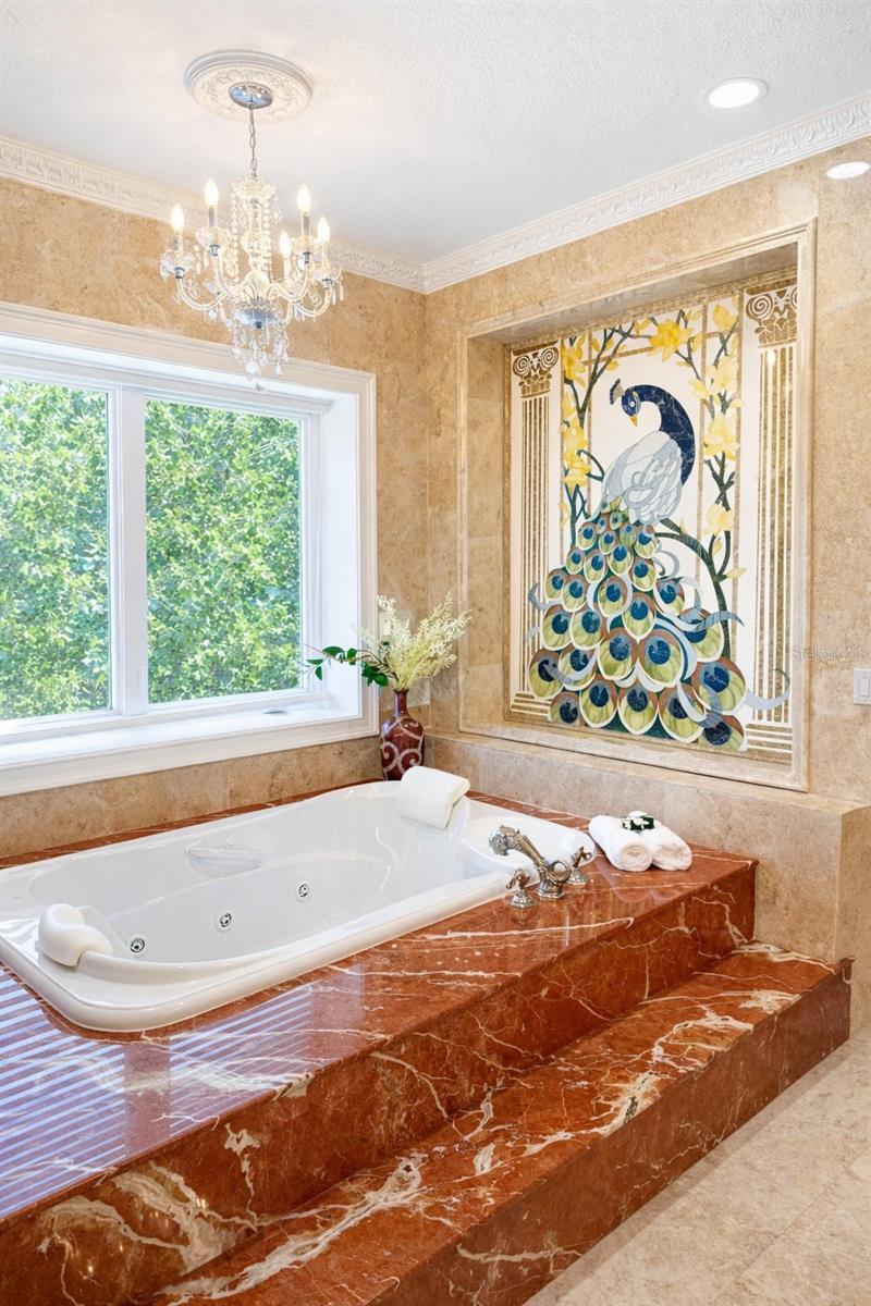 Phylrich dolphin fixtures, a Peacock inlaid in marble ,   a large sauna, soaking tub, multi-jet full-body rain shower, multiple vanities, and expansive custom closets