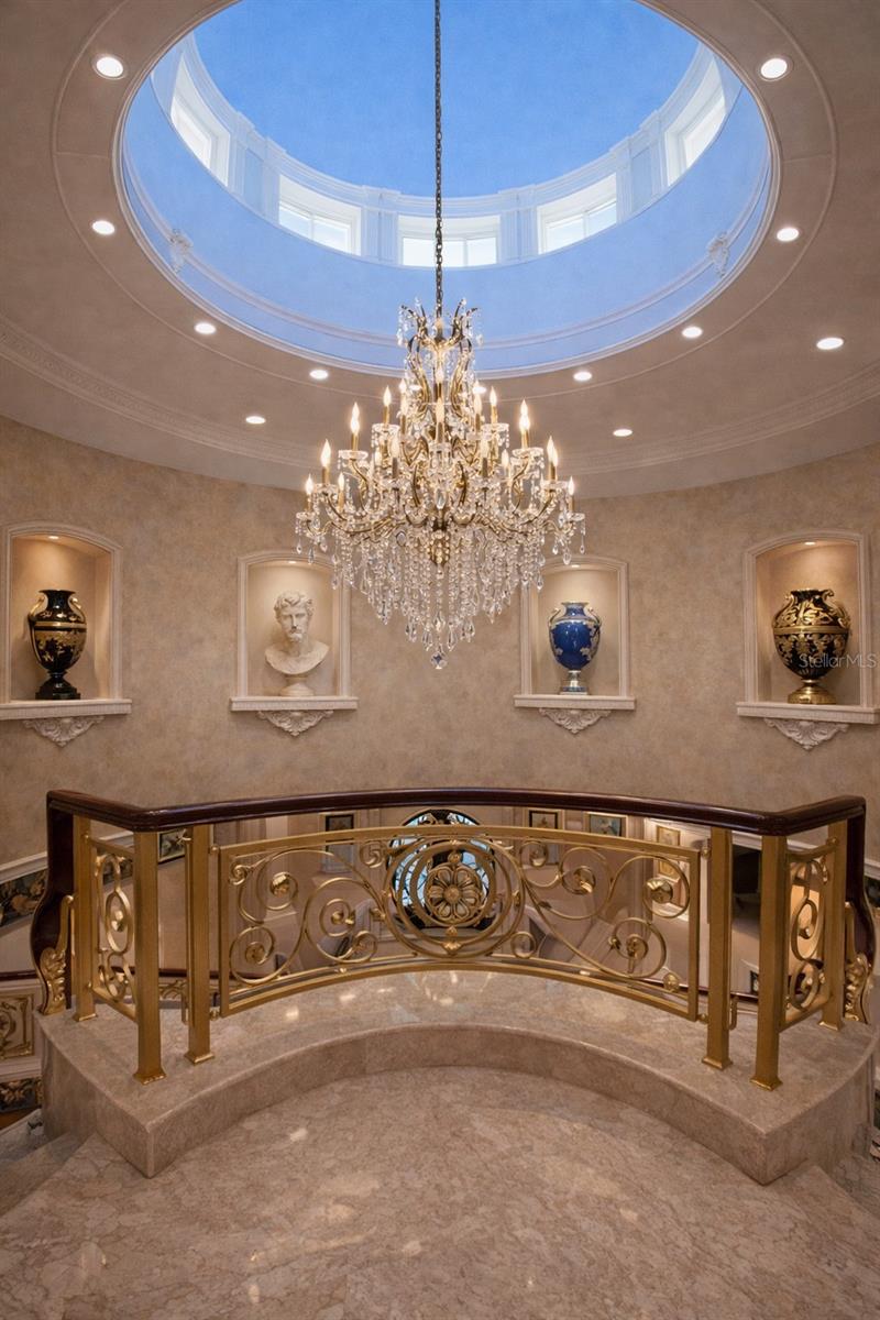 Hand-painted dome ceiling with custom chandelier creates a breathtaking focal point.
