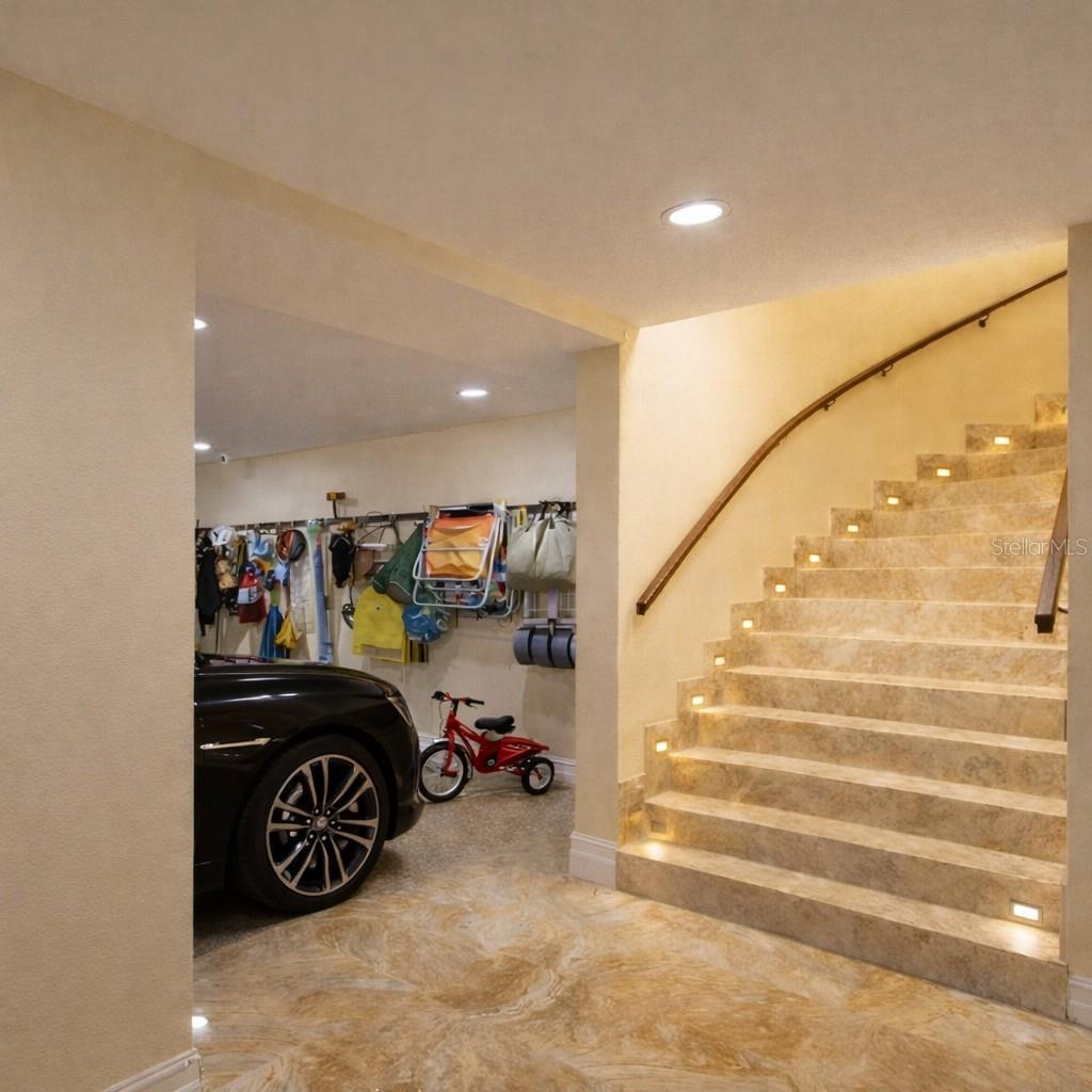A sweeping marble staircase reveals over 5,000 sq ft of additional living and entertaining space below.