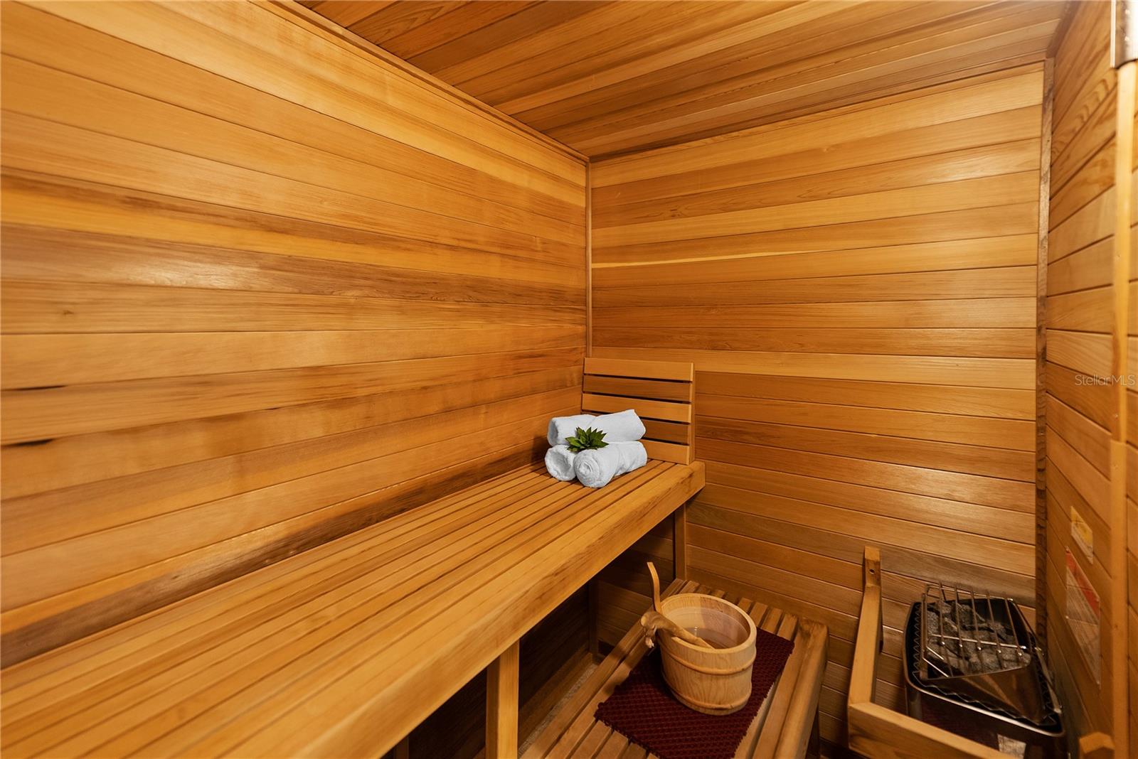 treat, featuring a spa-inspired marble ensuite bath with Phylrich fixtures, a large sauna, soaking tub, multi-jet full-body rain shower, multiple vanities, and expansive custom closets