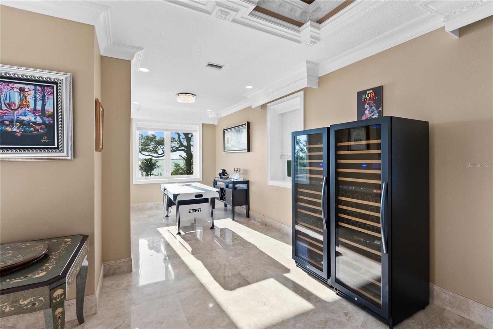 Expansive room with two ornate coffered ceilings—perfect for a pool table or game lounge.