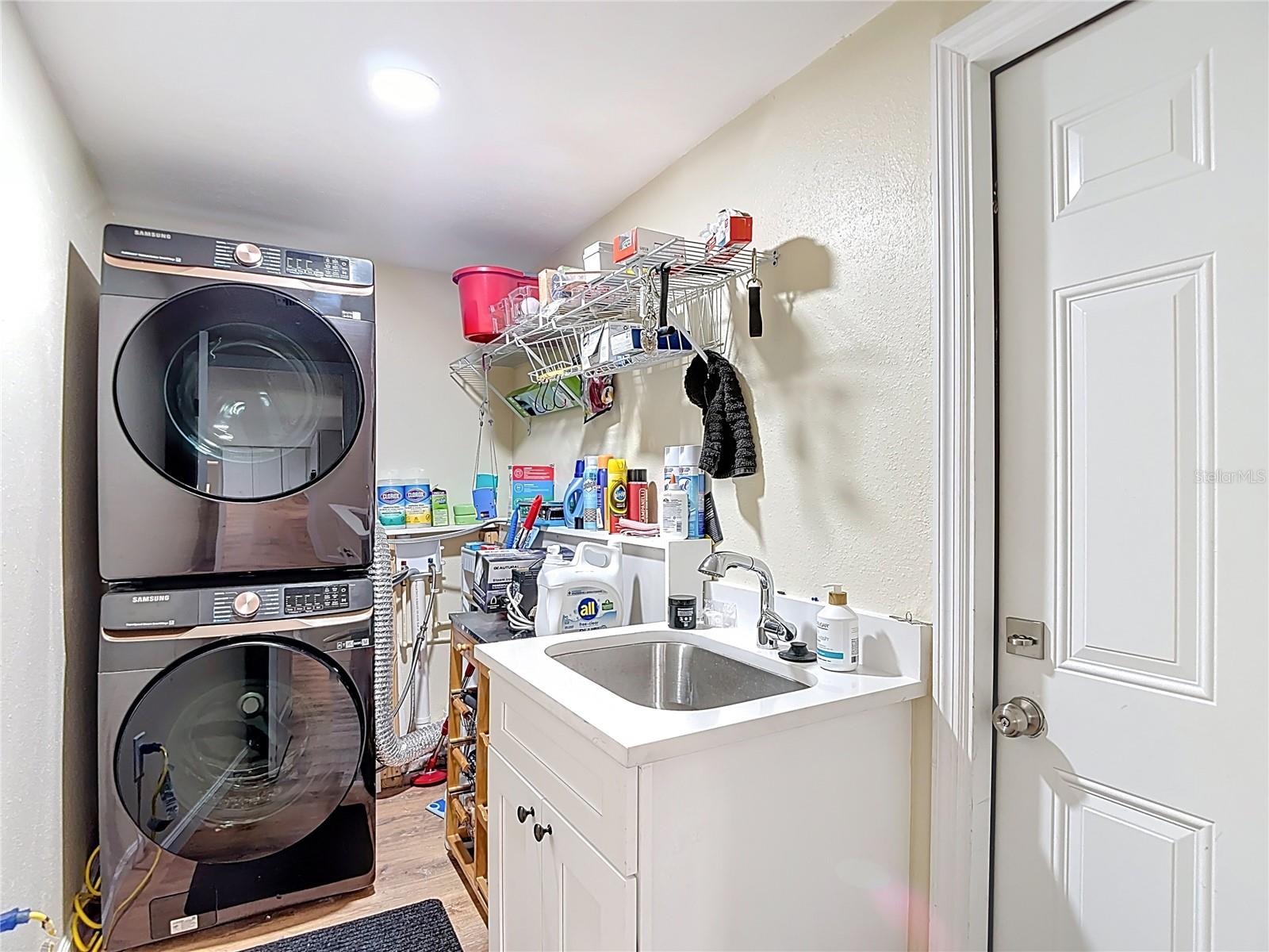 Inside laundry room with wash sink.