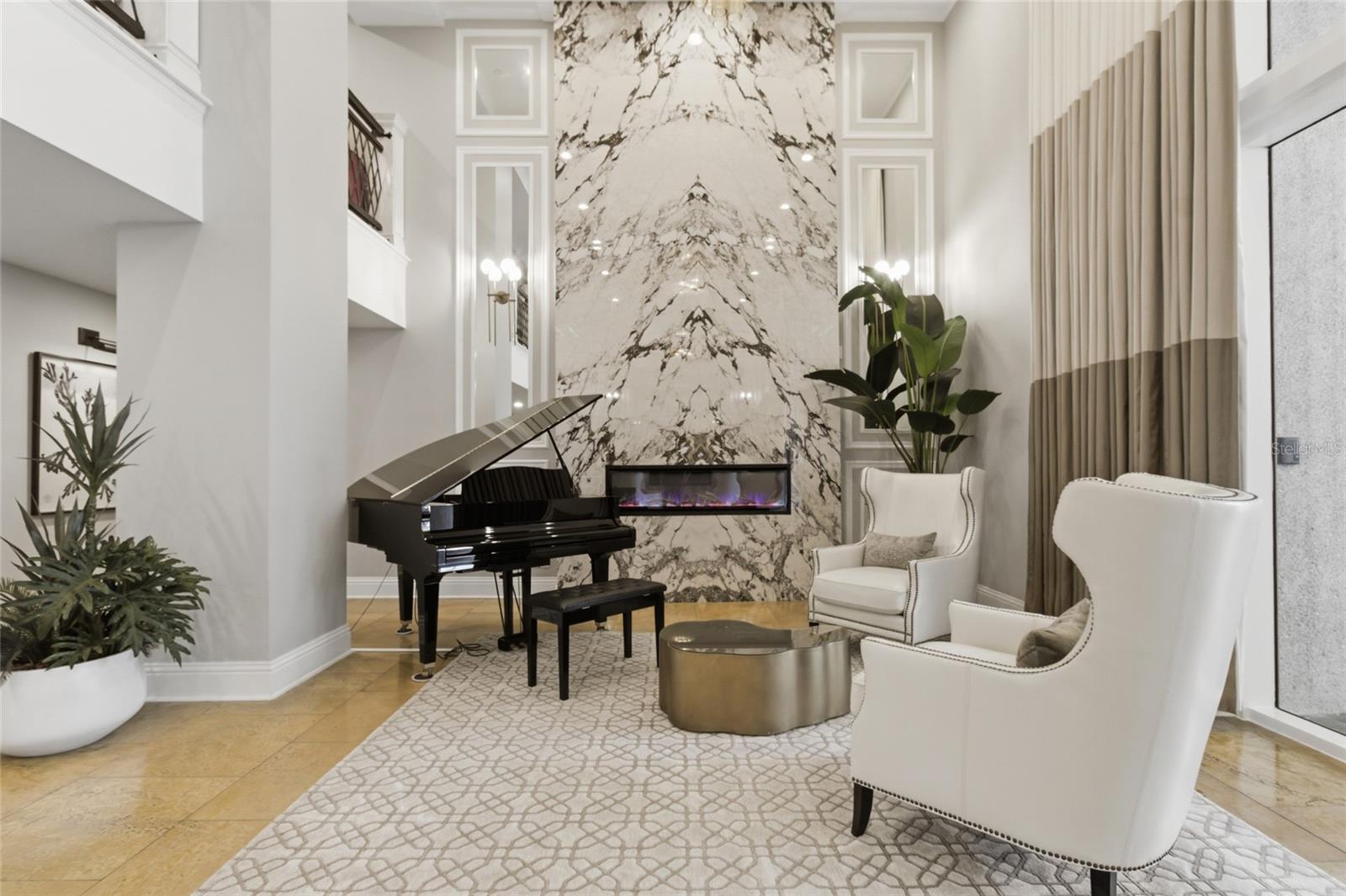 Lobby boating baby grand piano and cozy fireplace.