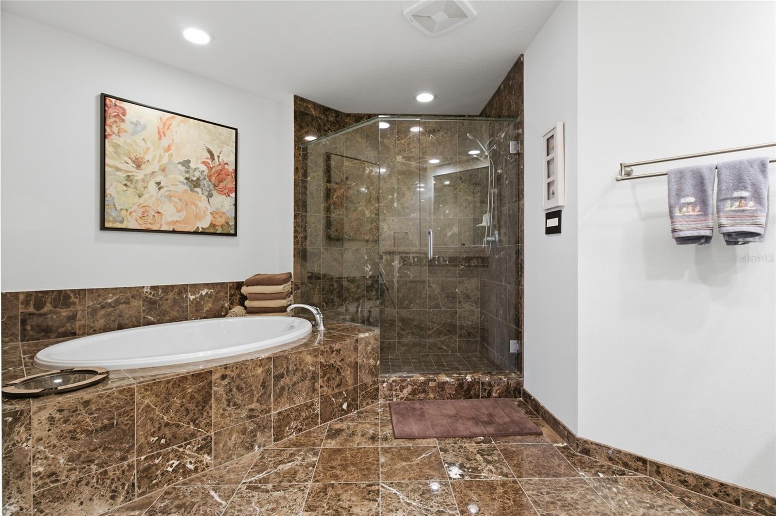 Primary bathroom offers soaking tub and walk in shower.