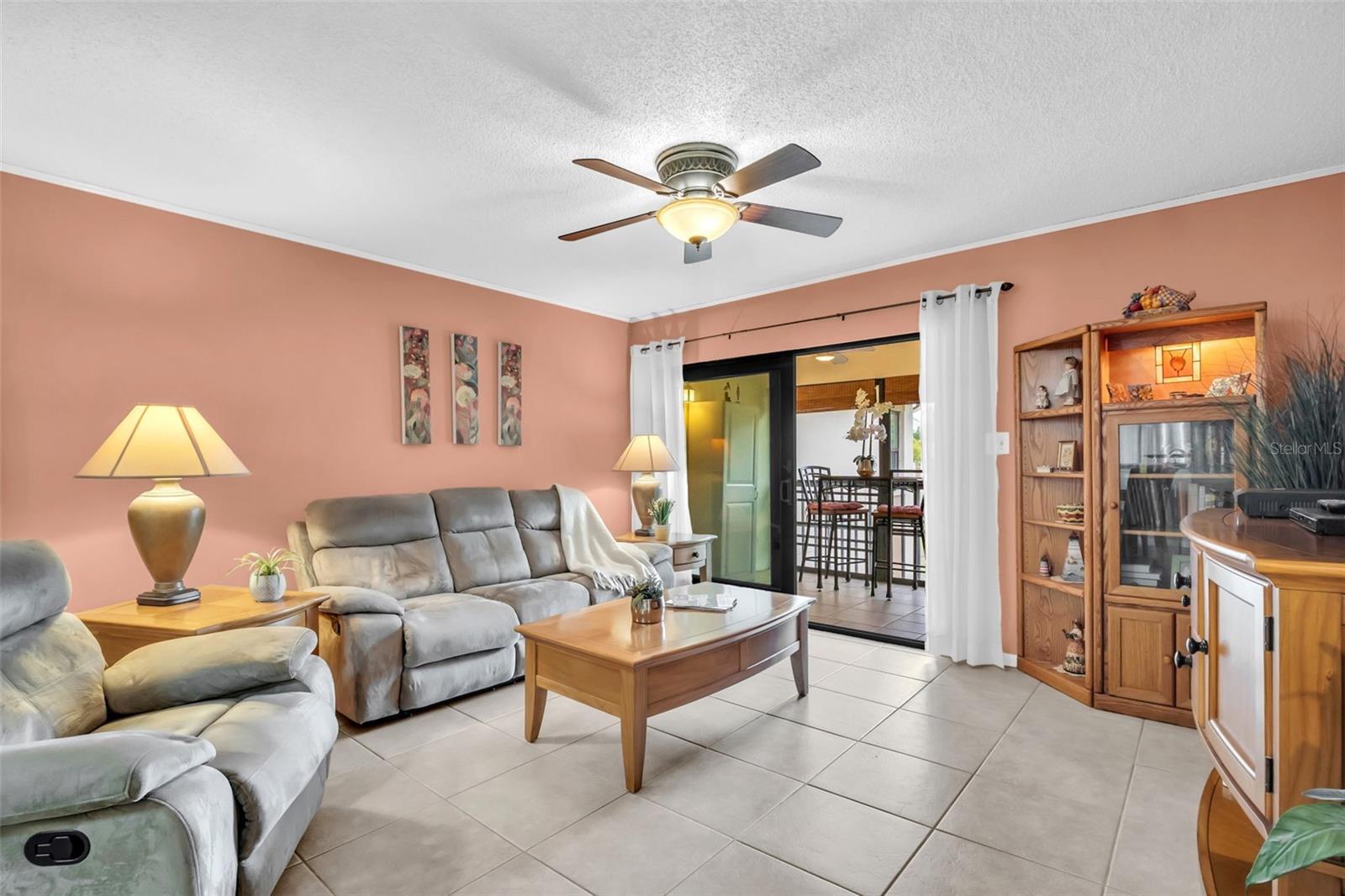 Hurricane-impact glass sliders to the screened balcony and large storage closet~