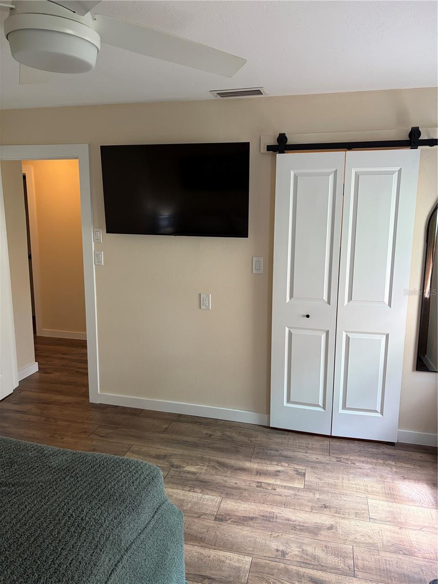 master bedroom and entrance sliding barn door to walkin closet