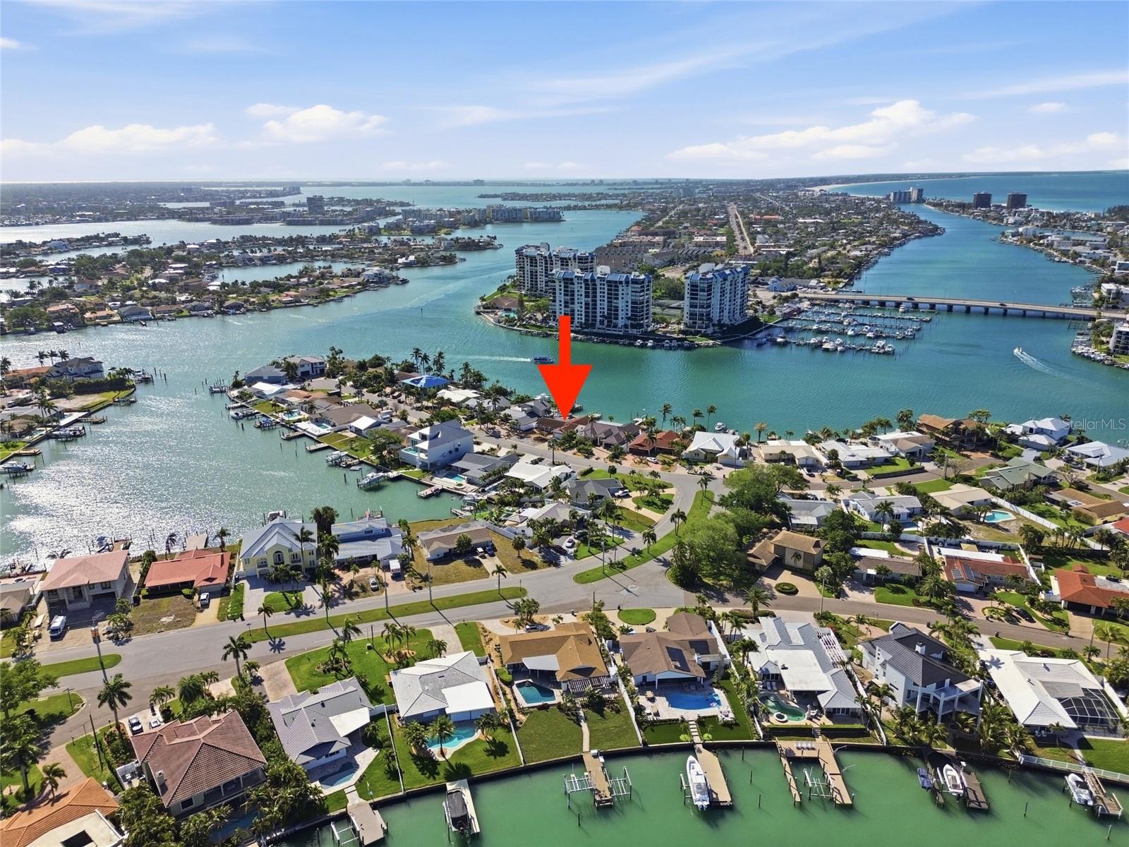 Drone photo of the broader Paradise Island neighborhood showing the Intracostal and the Gulf of Mexico to the right ("red arrow" indicates 4 Bellevue).