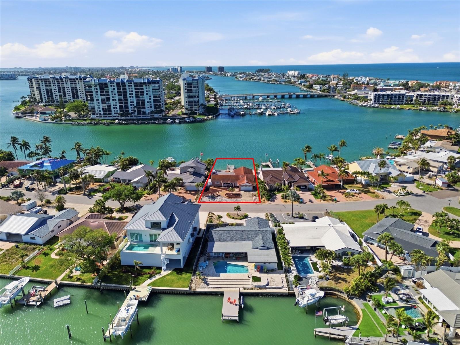 Drone shot looking down at 4 Bellevue and south to the Devil's Elbow and beyond the bridge leading to the beaches and the Gulf of Mexico.