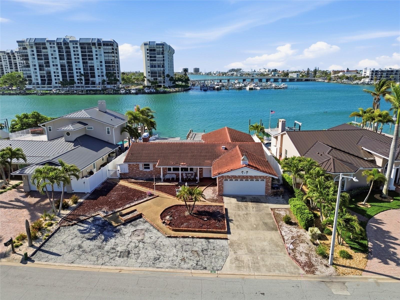 Drone shot of 4 Bellevue Drive looking south at The Devil's Elbow on the Intracoastal and the one bridge to the Gulf of Mexico in the foreground on the right (homes on either side are fully remediated).