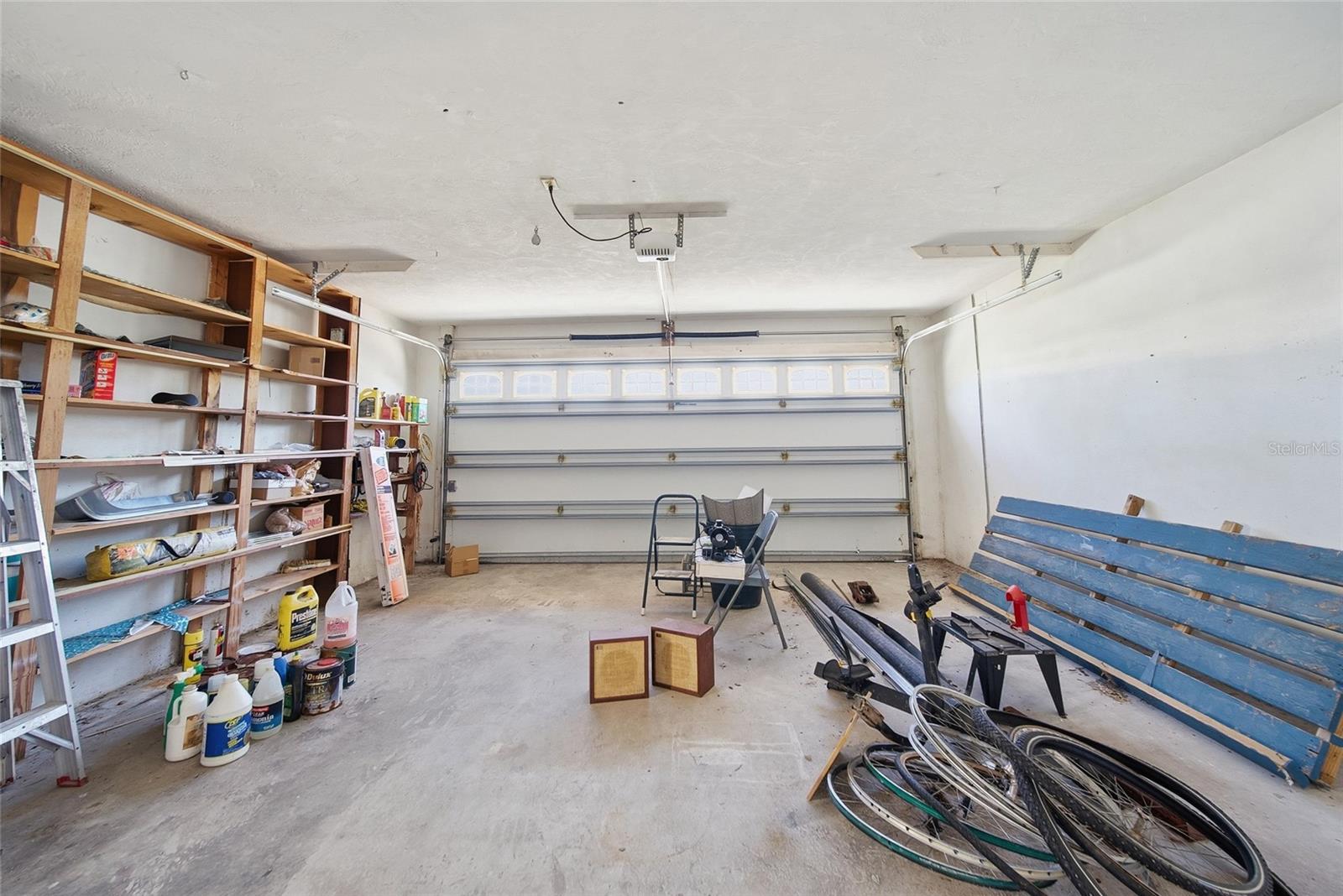 Double garage faces the street.  The existing space behind the garage includes a separate work room and laundry room.