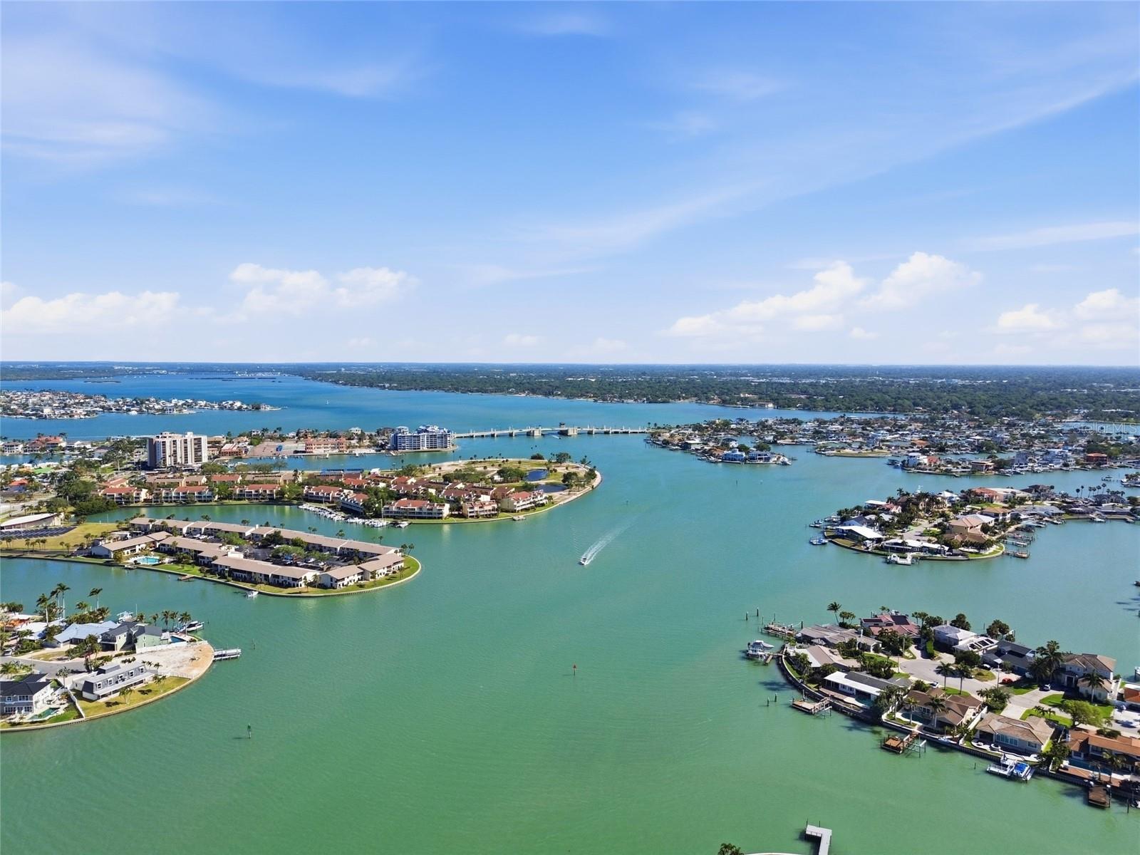 Aerial photo high above 4 Bellevue looking northwest towards Treasure Island Causeway drawbridge allowing access to the Gulf for sailboats and larger motorboats.