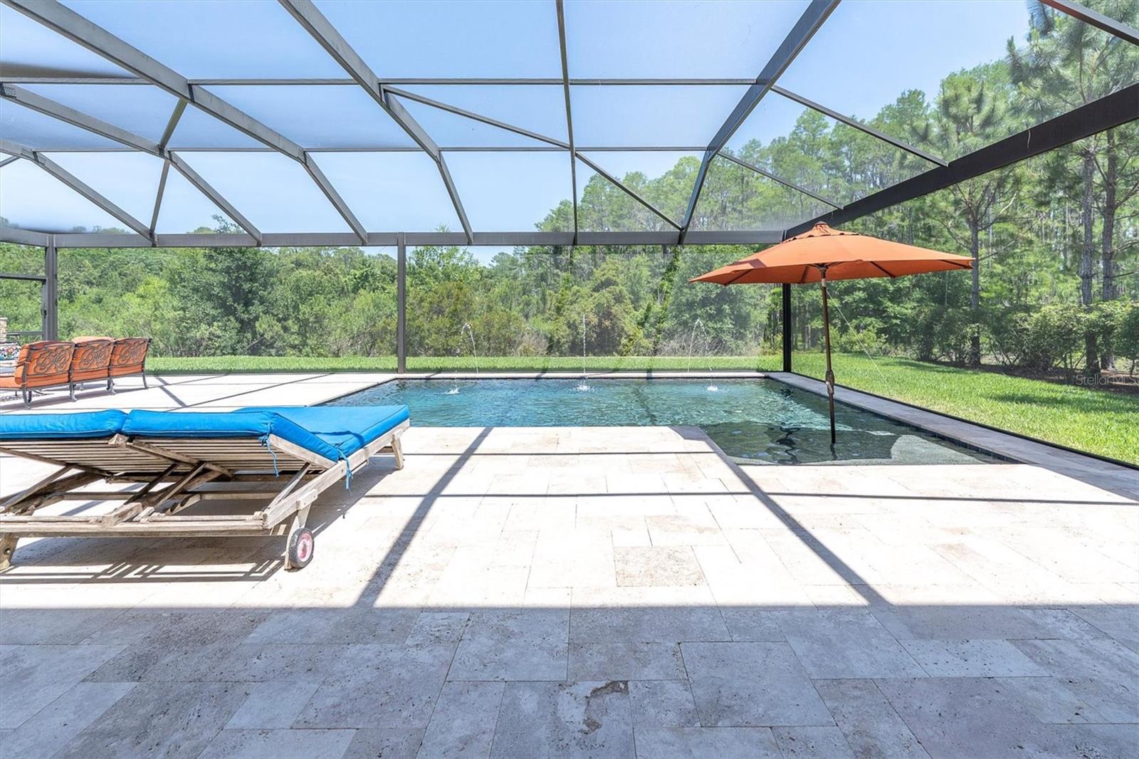 COOL TRAVERTINE DECK AFFORDS SPACE TO RELAX & ENTERTAIN
