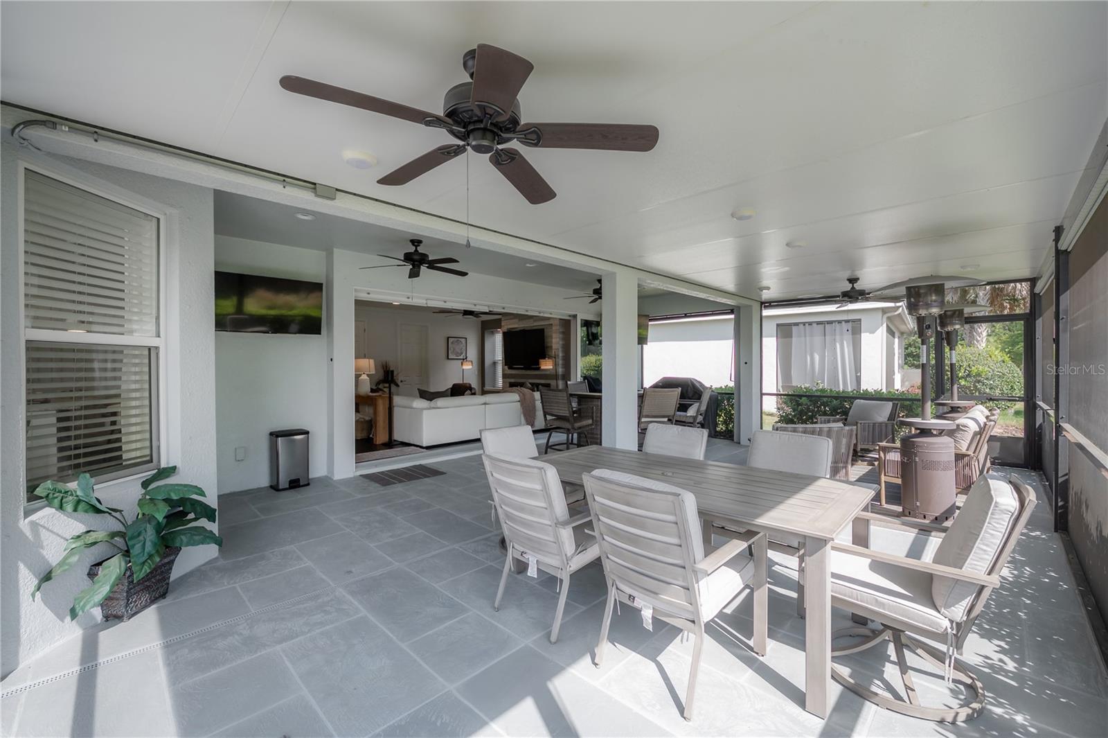 ndoor luxury meets outdoor serenity. This expansive screened lanai offers 600 sq ft of living space with custom shades, dual TVs, and a breathtaking 20’ pocket slider transition.