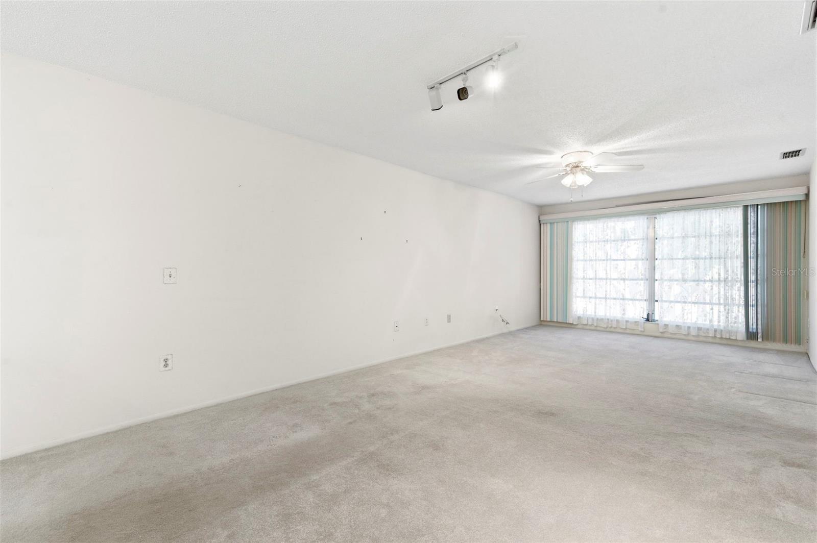 Ceiling fans throughout the home circulate cool breezes.